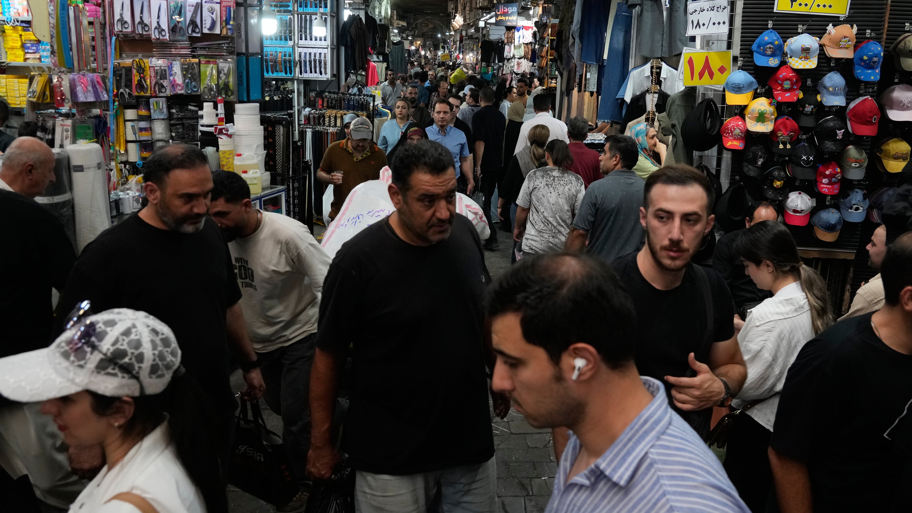 People walk in Tehran's traditional main bazaar, Iran, Saturday, Aug. 8, 2026. (AP Photo/Vahid Salemi)
