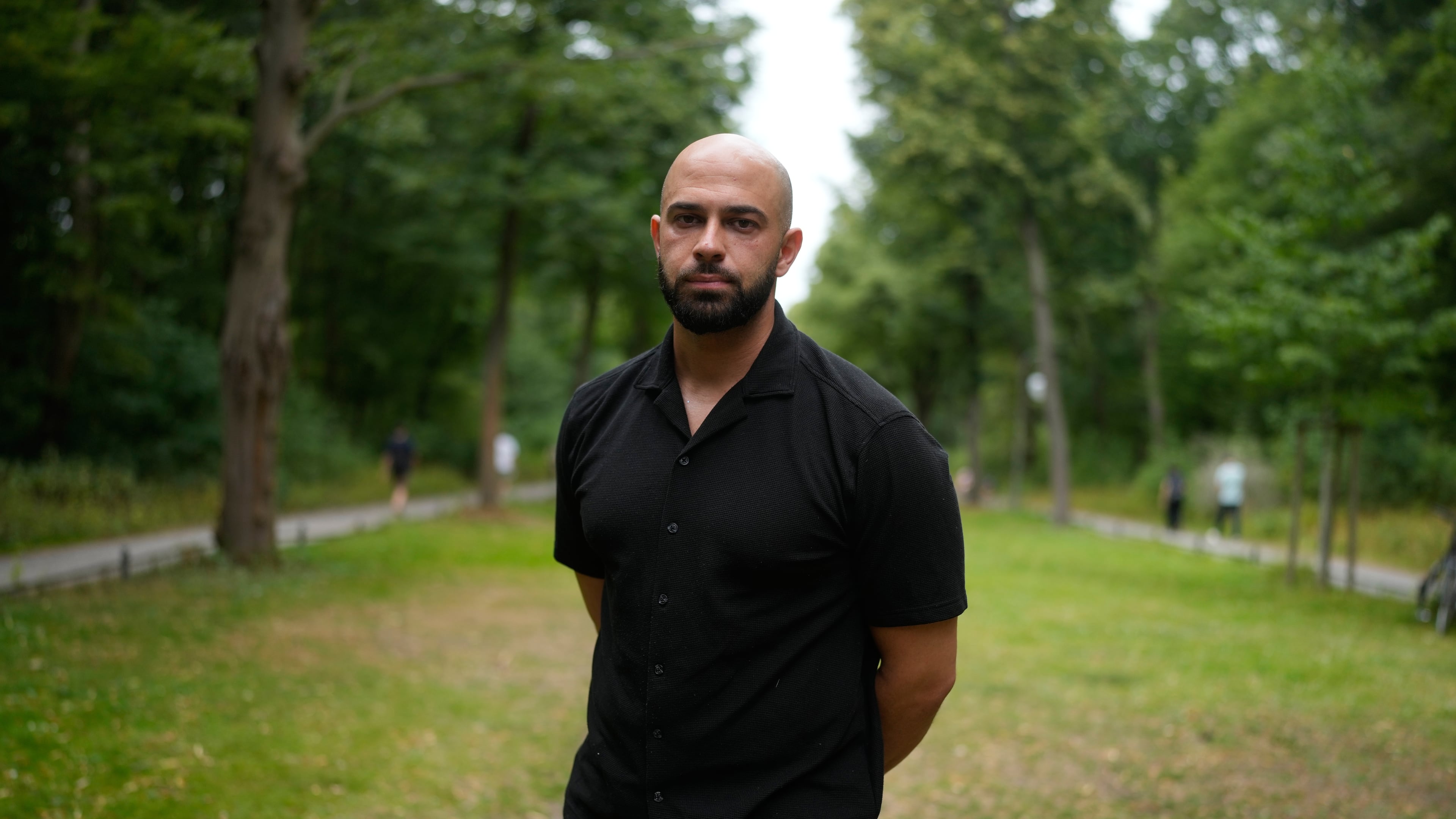 Police officer Ali Darwich poses for a portrait near the scene where a car rammed into a crowd at the Pride March in Berlin, Germany, Sunday, July 26, 2026. (AP Photo/Markus Schreiber)