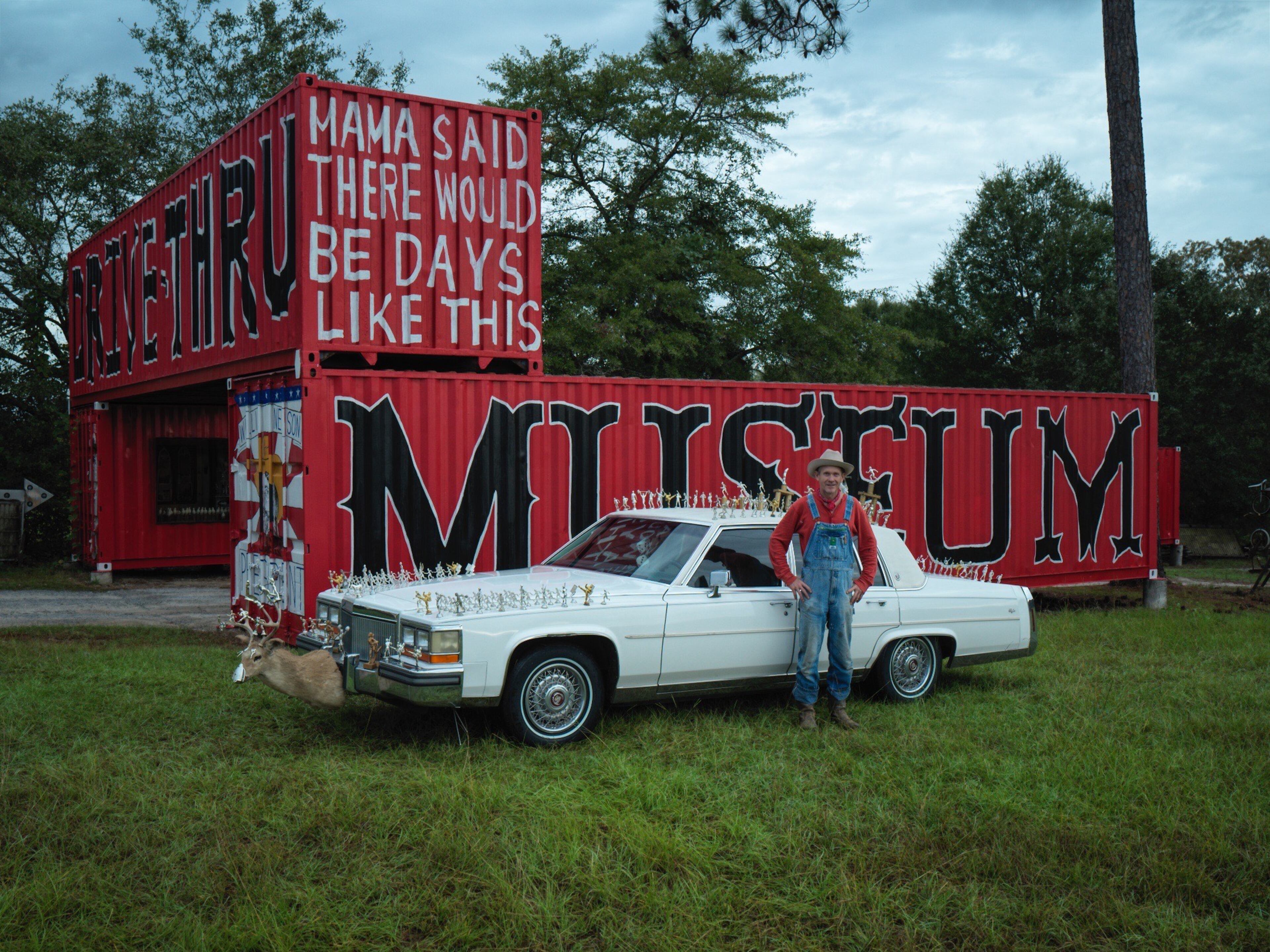 "Butch Anthony stands next to his decked-out white Cadillac at his one-of-kind drive-thru museum in rural Seale, Alabama."
Courtesy of Steve Plattner