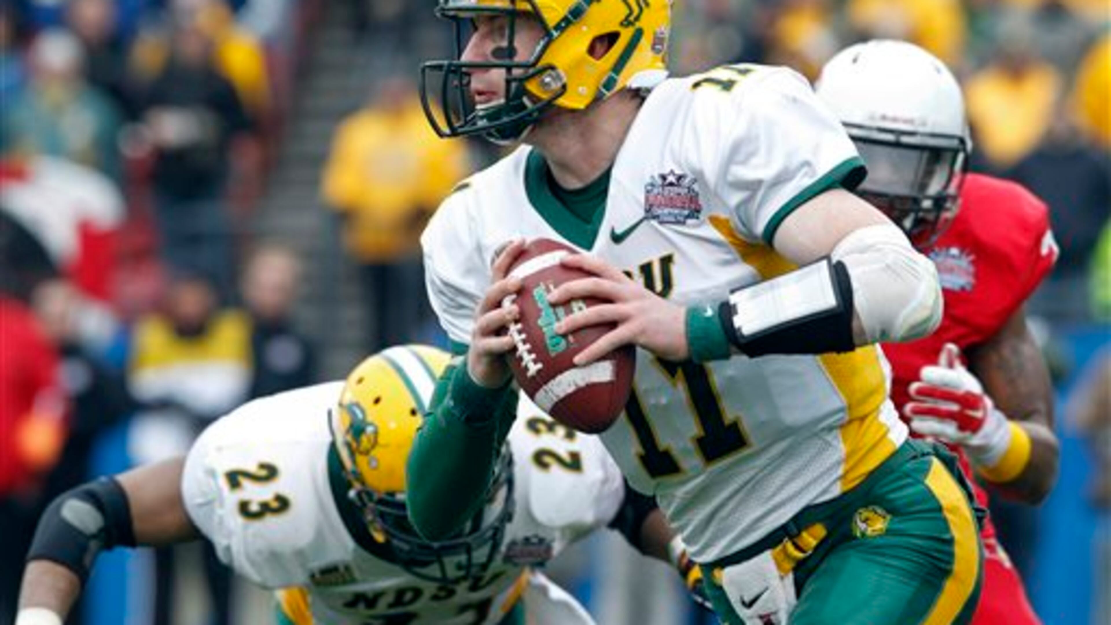 FILE - In this Jan. 10, 2016, file photo, North Dakota State quarterback Carson Wentz (11) carries the ball during the FCS championship NCAA college football game against Illinois State in Frisco, Texas. Wents is one of the top offensive players available in the NFL Draft, which starts April 28 in Chicago. (AP Photo/Tim Sharp, File)