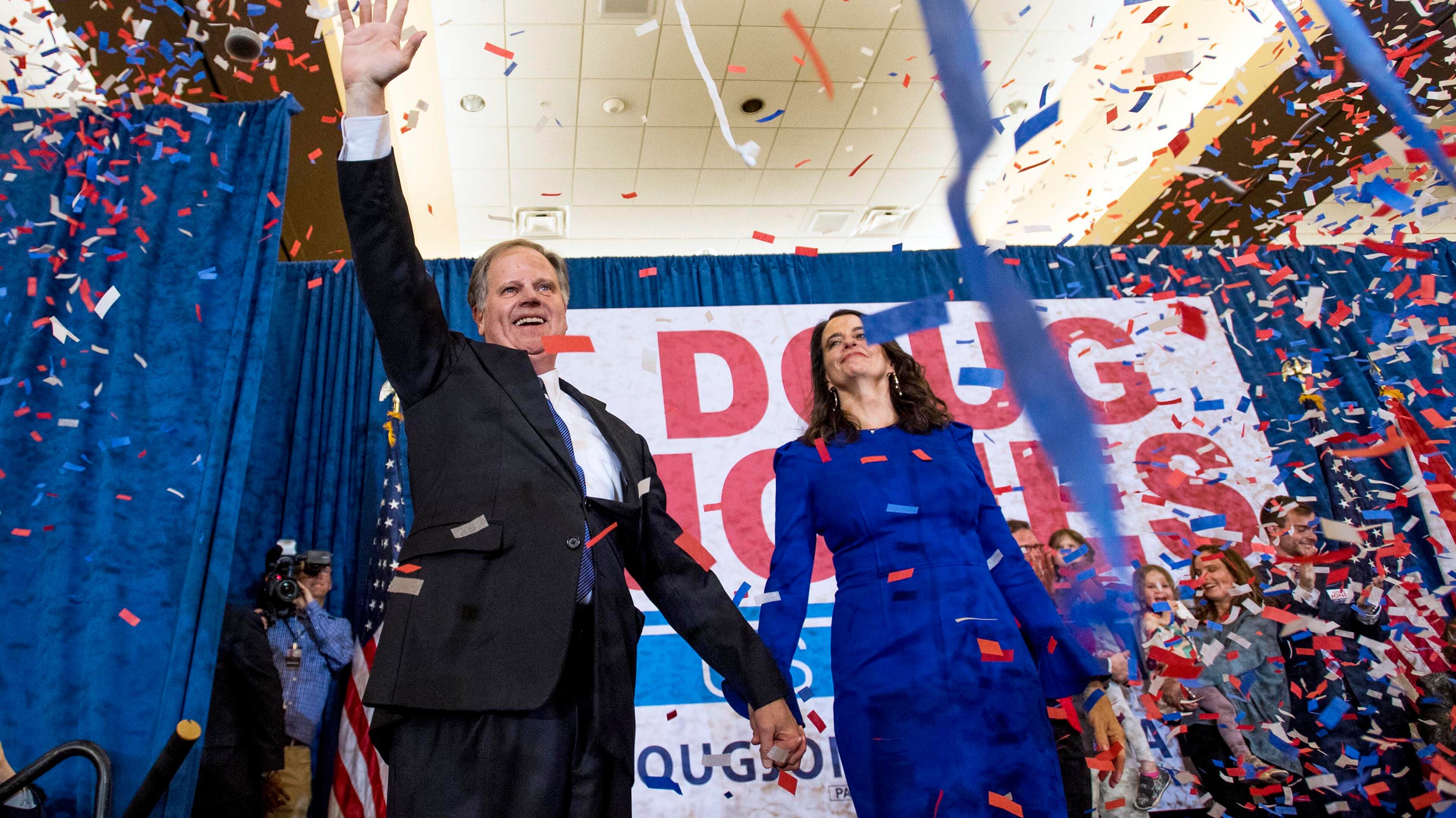 Doug Jones and his wife Louise greet supporters as he claims victory at his watch party in Birmingham.