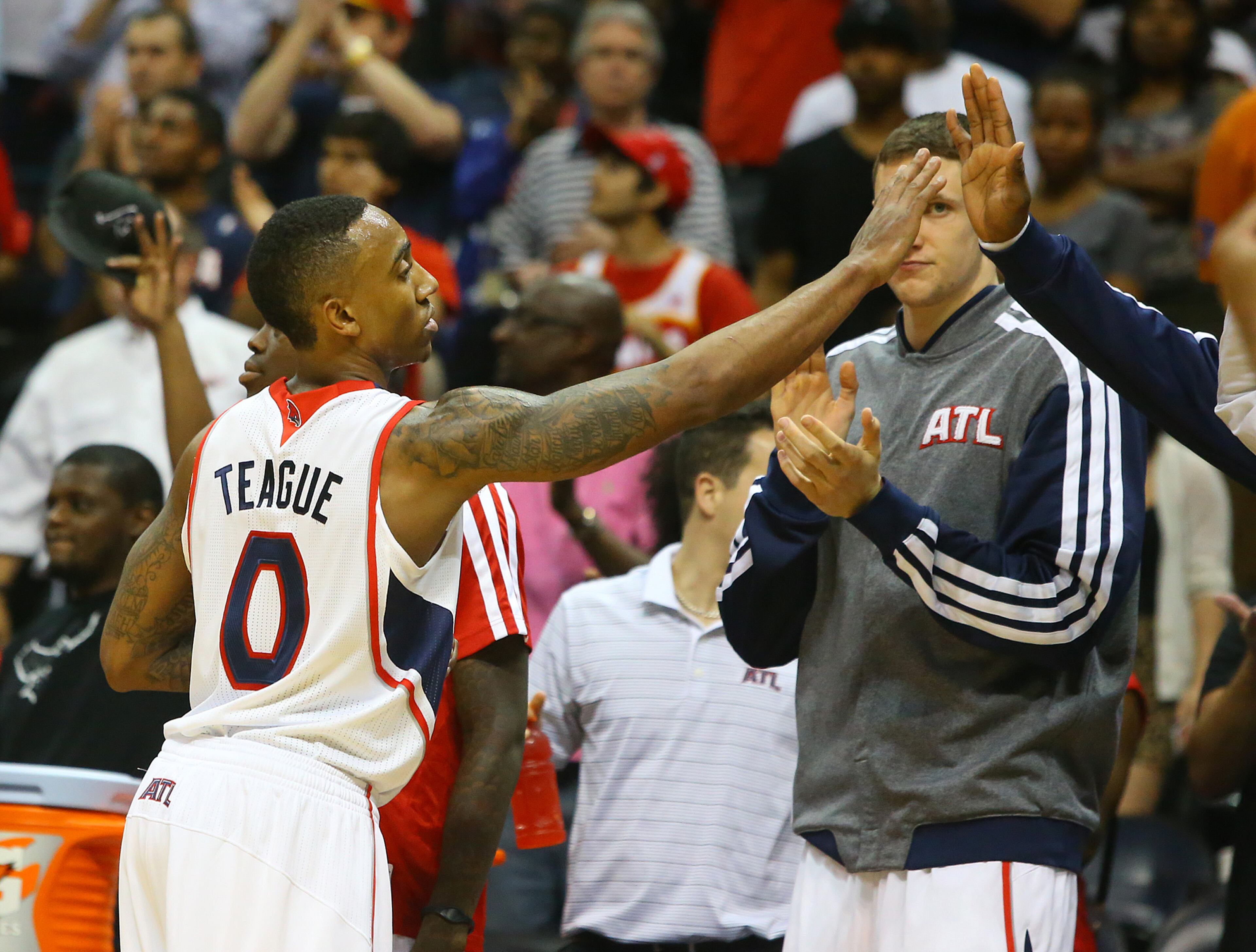 Jeff Teague gets high fives from teammates coming out of the game in the final minute beating the Pacers 98-85 for a 2 games to 1 lead during the second half of their NBA playoff game on Thursday, April 24, 2014, in Atlanta. CURTIS COMPTON / CCOMPTON@AJC.COM
