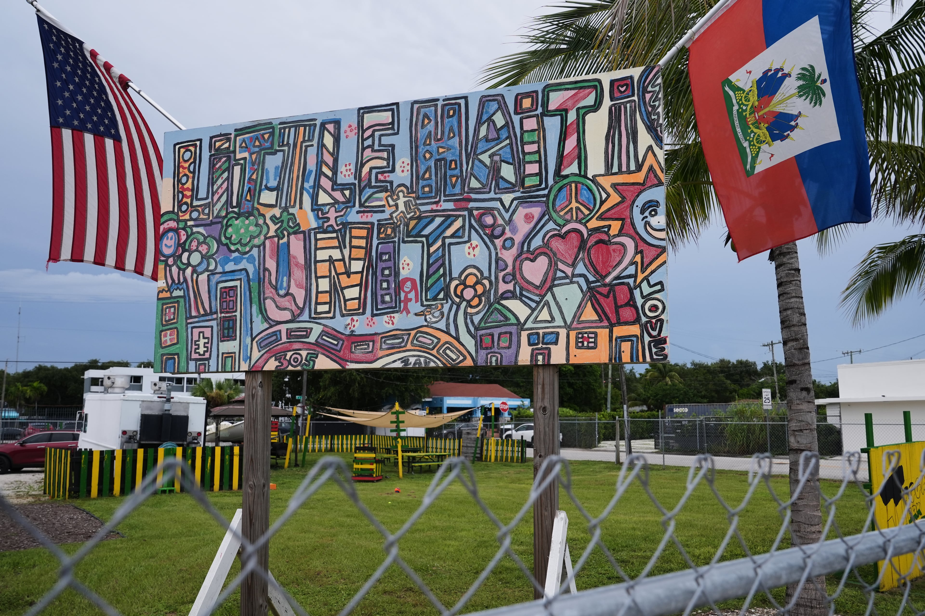 An American and a Haitian flag both hang from a sign reading “Little Haiti Unity” on Wednesday, Aug. 5, 2026, in the Little Haiti neighborhood of Miami. (Lynne Sladky/AP)