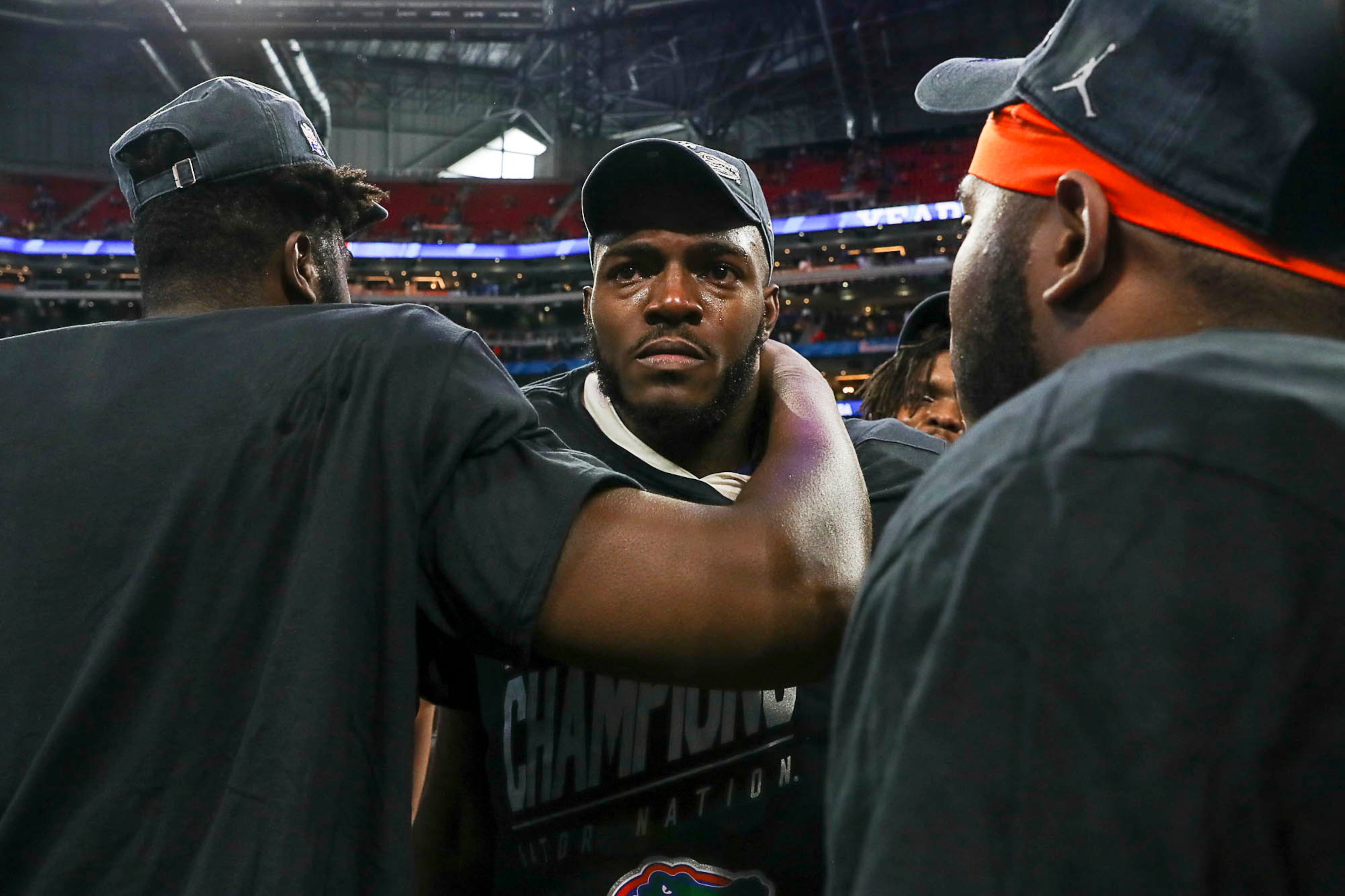 12/29/2018 -- Atlanta, Georgia -- Florida Gators tight end C'yontai Lewis (center) is comforted by his teammates as he becomes emotional following a win by the Florida Gators during the Chick-fil-A Peach Bowl at Mercedes-Benz Stadium in Atlanta, Saturday, December 29, 2018. The Florida Gators beat the Michigan Wolverines, 41-15. (ALYSSA POINTER/ALYSSA.POINTER@AJC.COM)