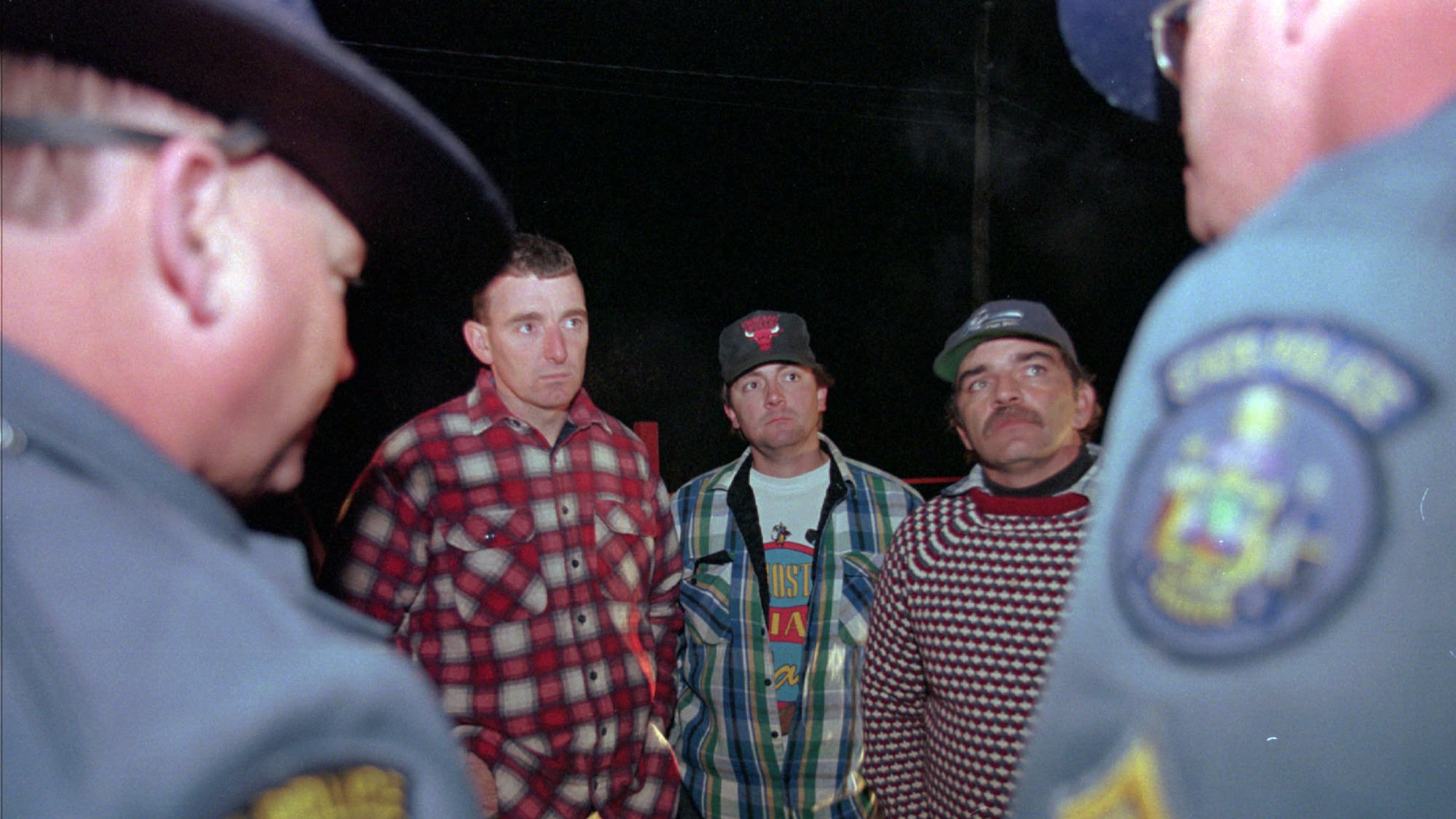 FILE - Maine loggers Stacey Kelly, second from left, Troy Jackson, and Hilton Hafford are threatened with arrest by Maine State Police if they continue to block access to Canadian woodsmen at the border at St. Pamphile, Quebec, Monday, Oct. 26, 1998. (AP Photo/Robert F. Bukaty,File)