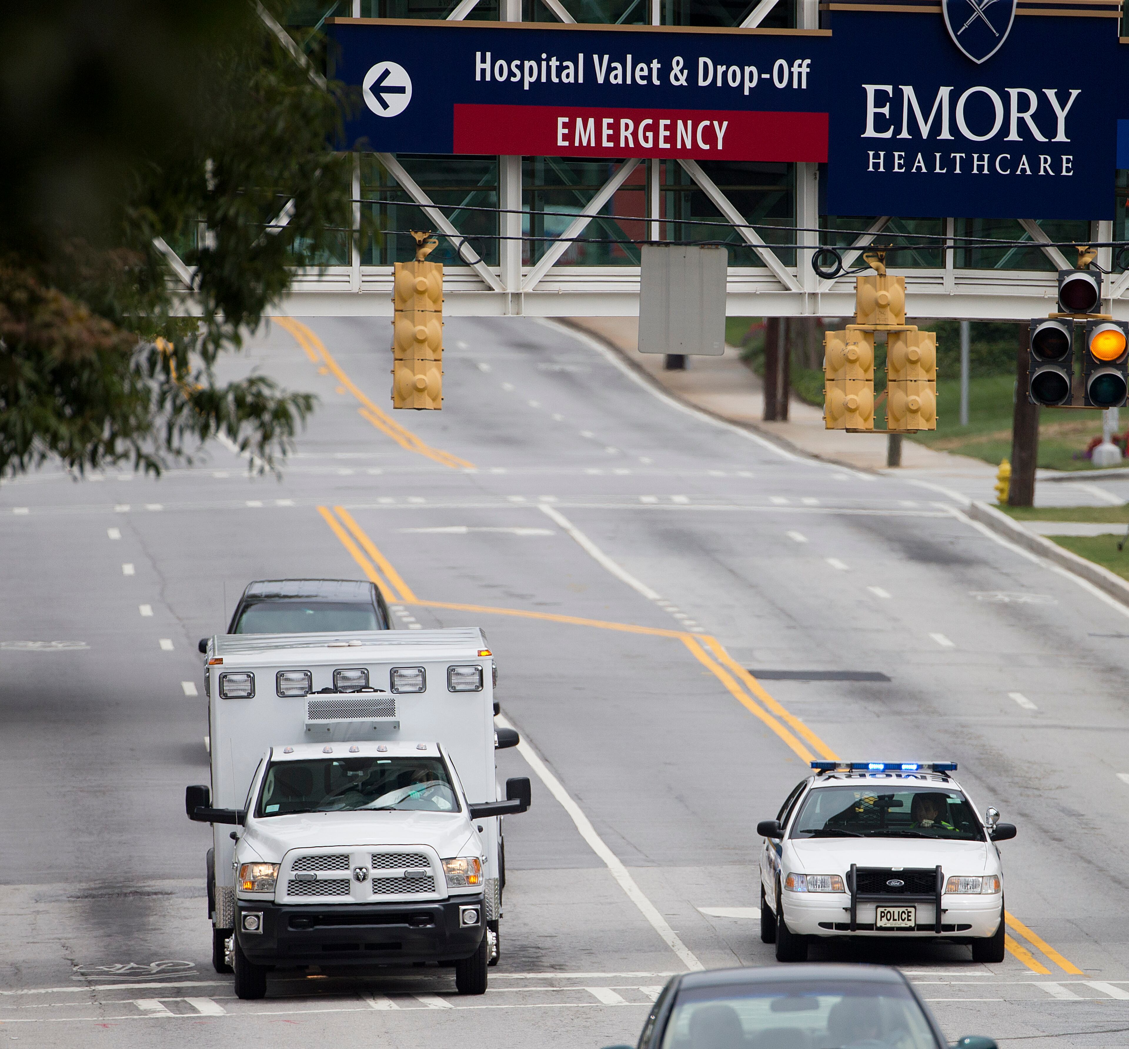 An ambulance arrives at Emory University Hospital transporting an American that was infected with the Ebola virus, Saturday, Aug. 2, 2014, in Atlanta. A specially outfitted plane carrying Dr. Kent Brantly from West Africa arrived at a military base in Georgia. Brantly was taken to the Atlanta hospital. Another American with Ebola is expected to join him at the hospital in a few days. (AP Photo/David Goldman)