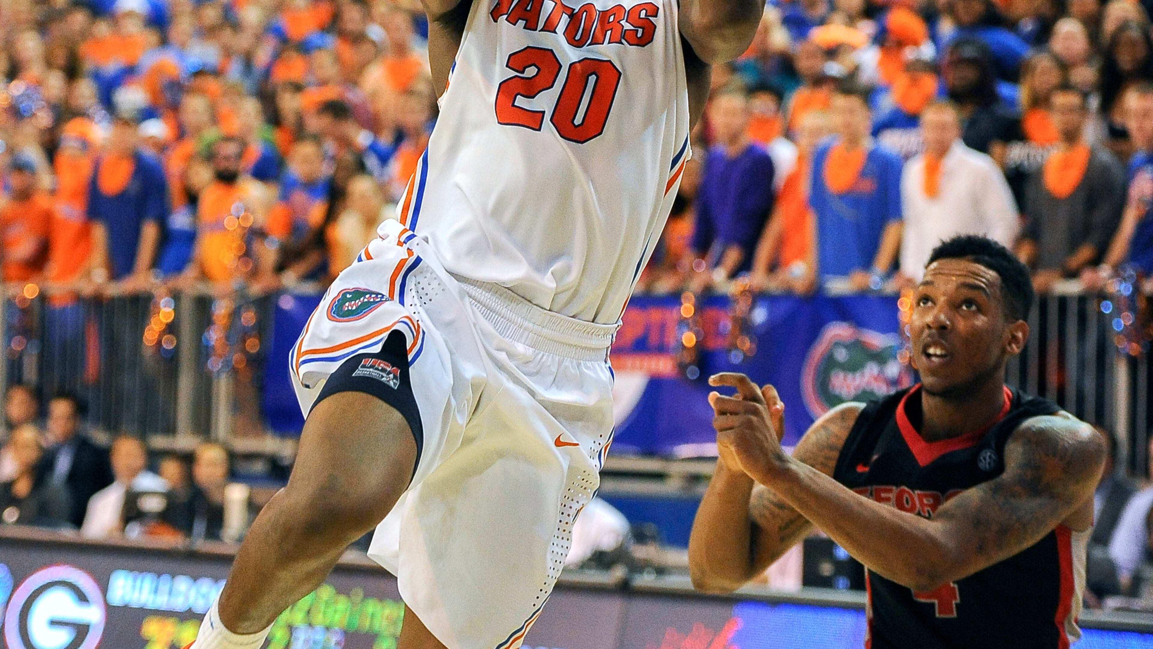 Florida guard Michael Frazier II (20) goes for a shot as Georgia guard Charles Mann (4) watches during the second half of an NCAA college basketball game, Tuesday, Jan. 14, 2014, in Gainesville, Fla. Florida won 72-50. (AP Photo/Phil Sandlin)