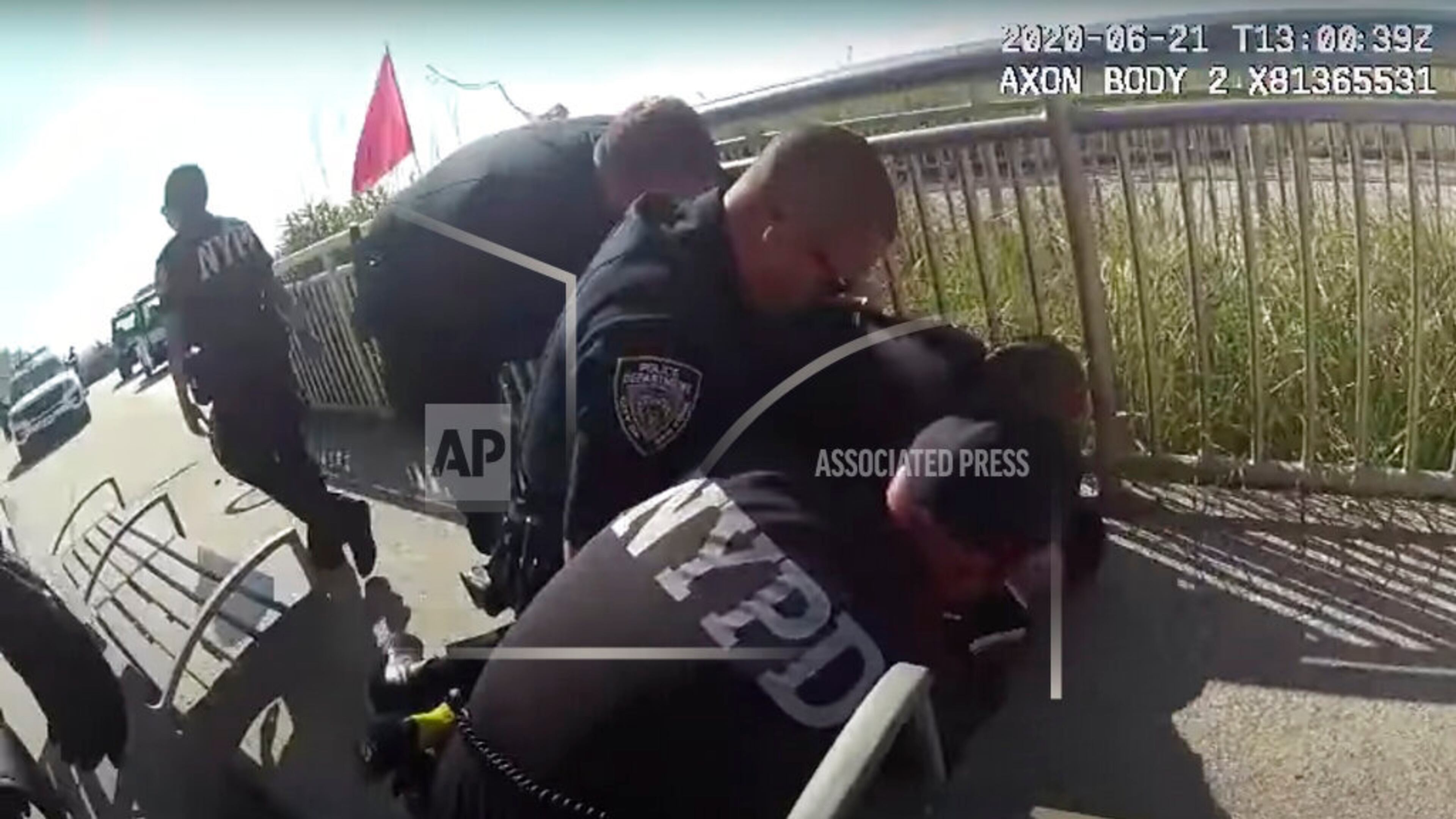 In this photo taken from police body cam video, New York Police officers arrest a man on a boardwalk Sunday, June 21, 2020, in New York. New York City Police Commissioner Dermot Shea says a police officer was quickly suspended without pay after putting his arm around the man's neck because we are living in "unprecedented times." Shea announced the suspension on Sunday just hours after the officer used what the commissioner called "an apparent chokehold" during a confrontation on a boardwalk in the Rockaway section of Queens. (NYPD via AP)