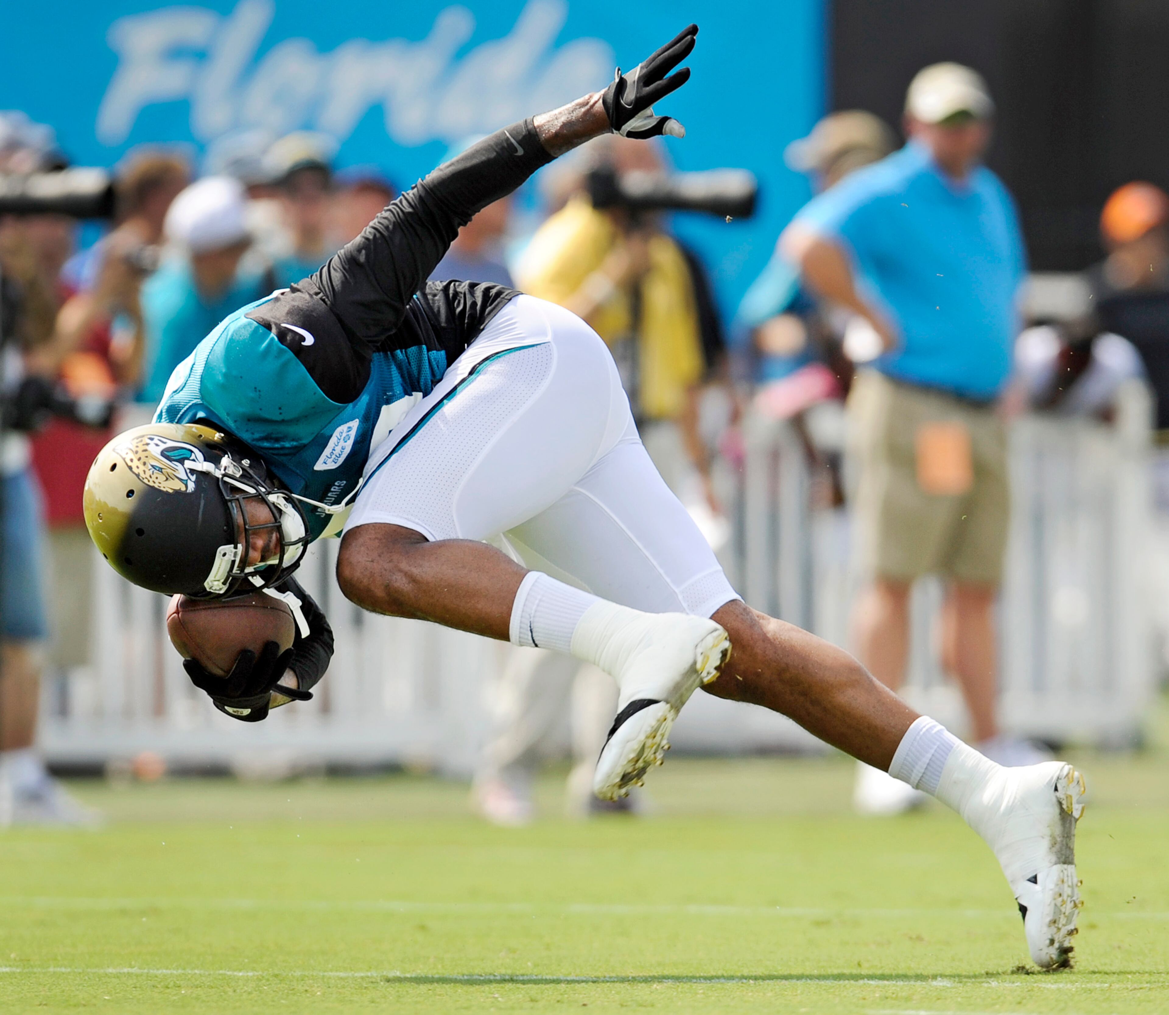 Jacksonville Jaguars' Marcedes Lewis struggles to stay on his feet after pulling in a pass during NFL football drills at a training camp session on Wednesday, July 31, 2013, in Jacksonville, Fl. (AP Photo/The Florida Times-Union, Bob Self) TV OUT