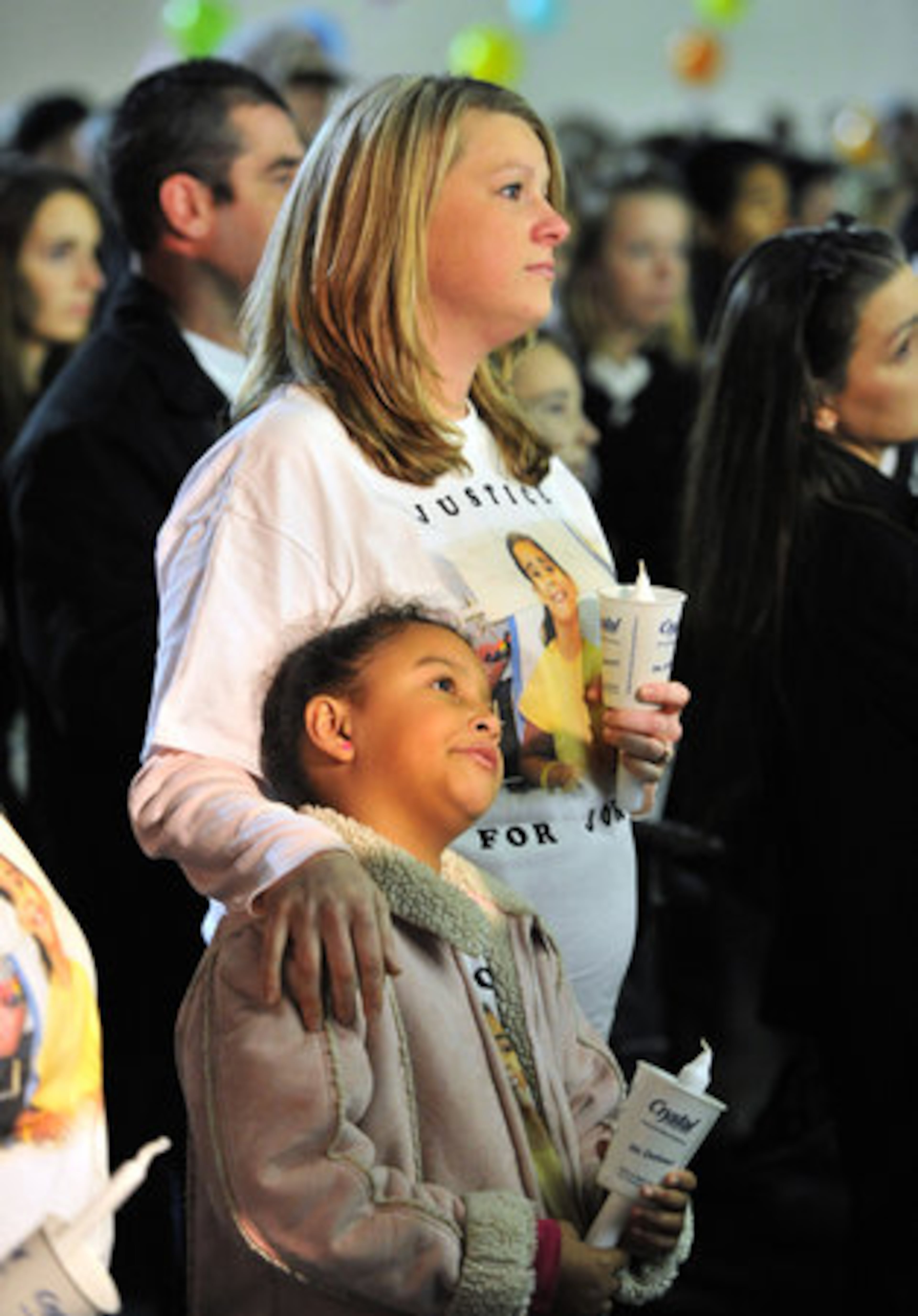 Kimberly Shook, of Cartersville, and her 8-year old daughter Nadia Hall hold candles.