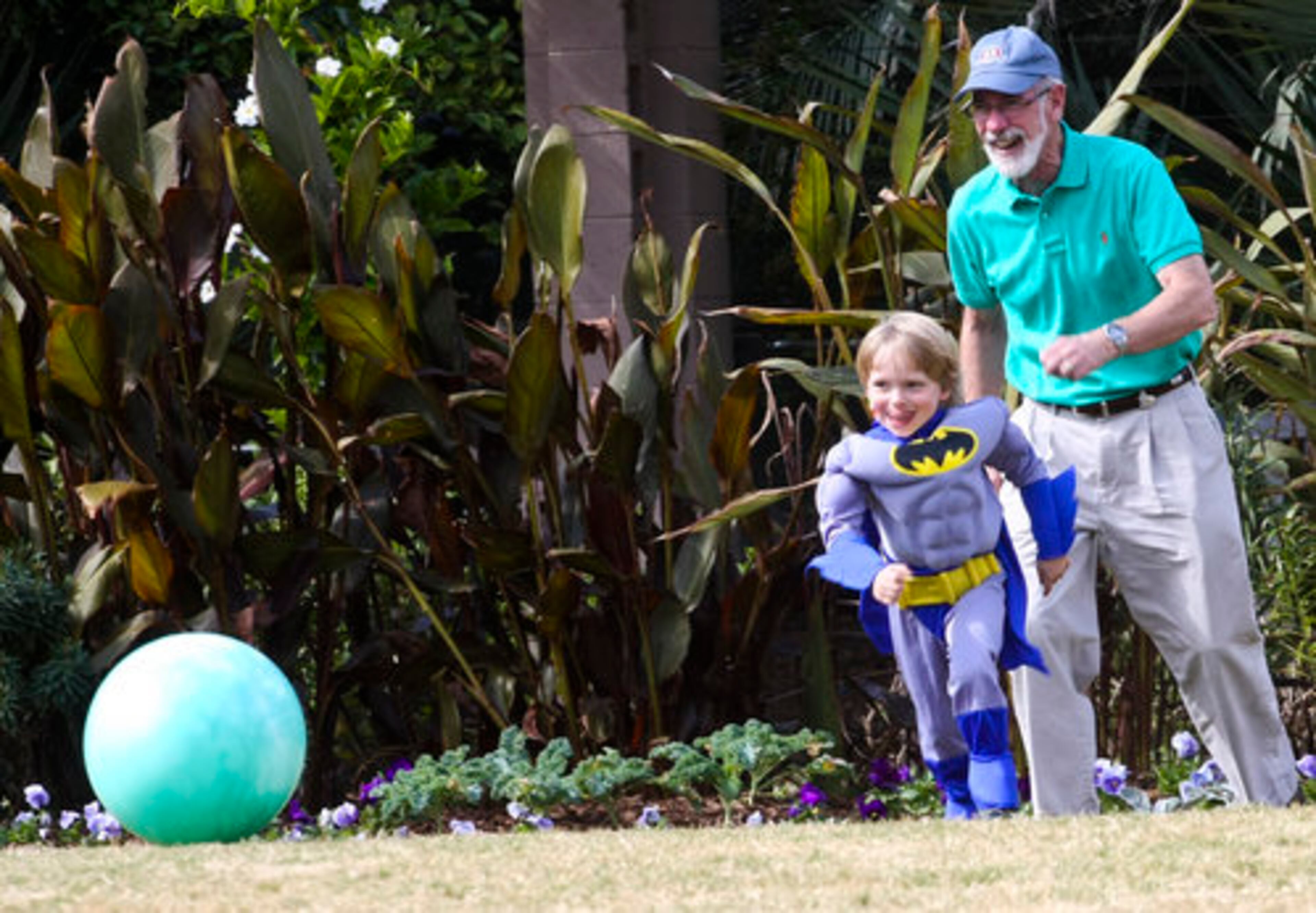 Four-year-old Luke Livingston and his grandfather David Livingston of Dunwoody kill time with a game of soccer before jumping onto the miniature train during Atlanta Botanical Garden's annual Goblins in the Garden, Sunday, October 24, 2010.