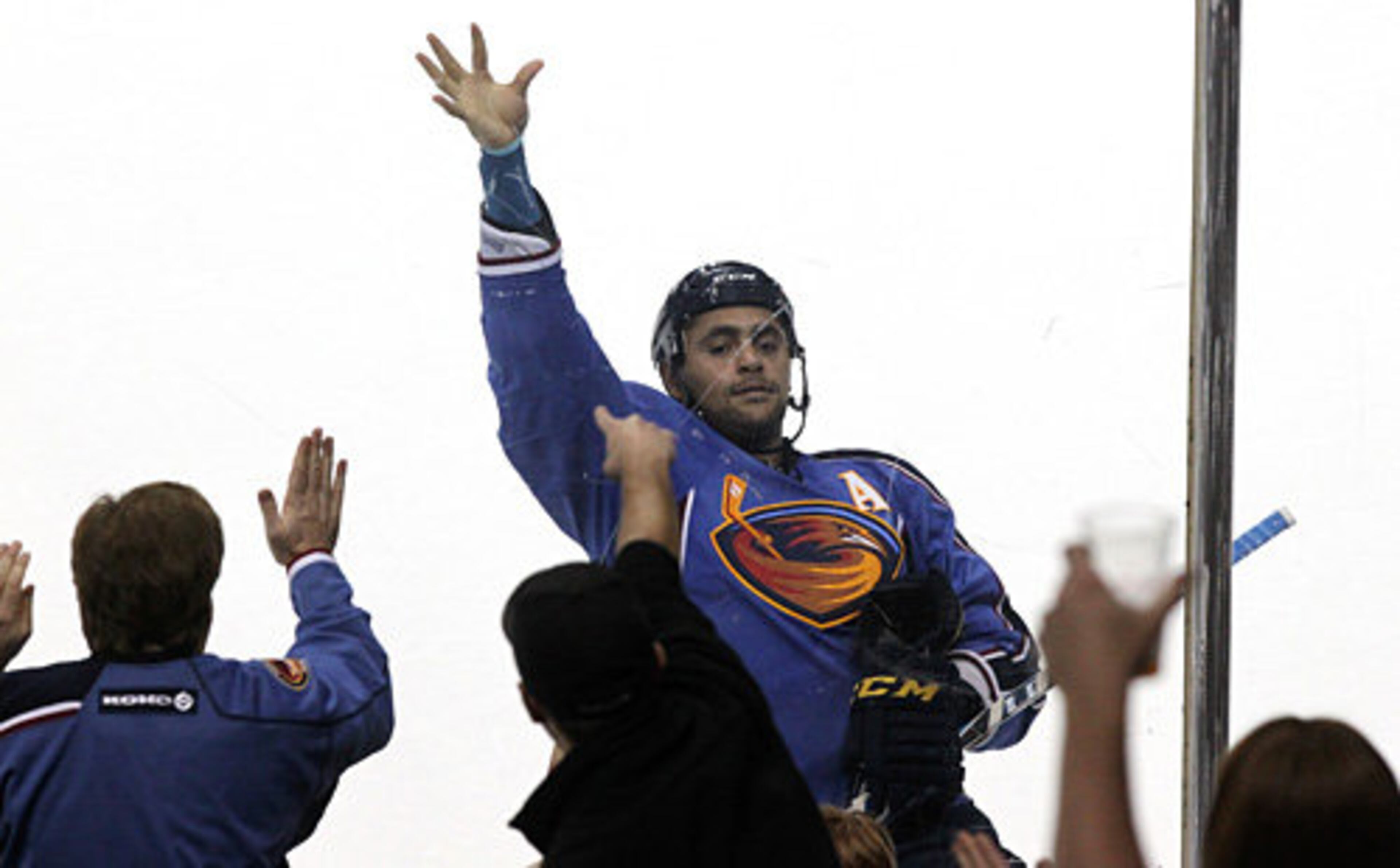 Atlanta's Dustin Byfuglien grabs his jersey and plays to the cheering fans as he scores the game-winning goal against the New York Islanders during sudden death overtime for a 2-1 victory.