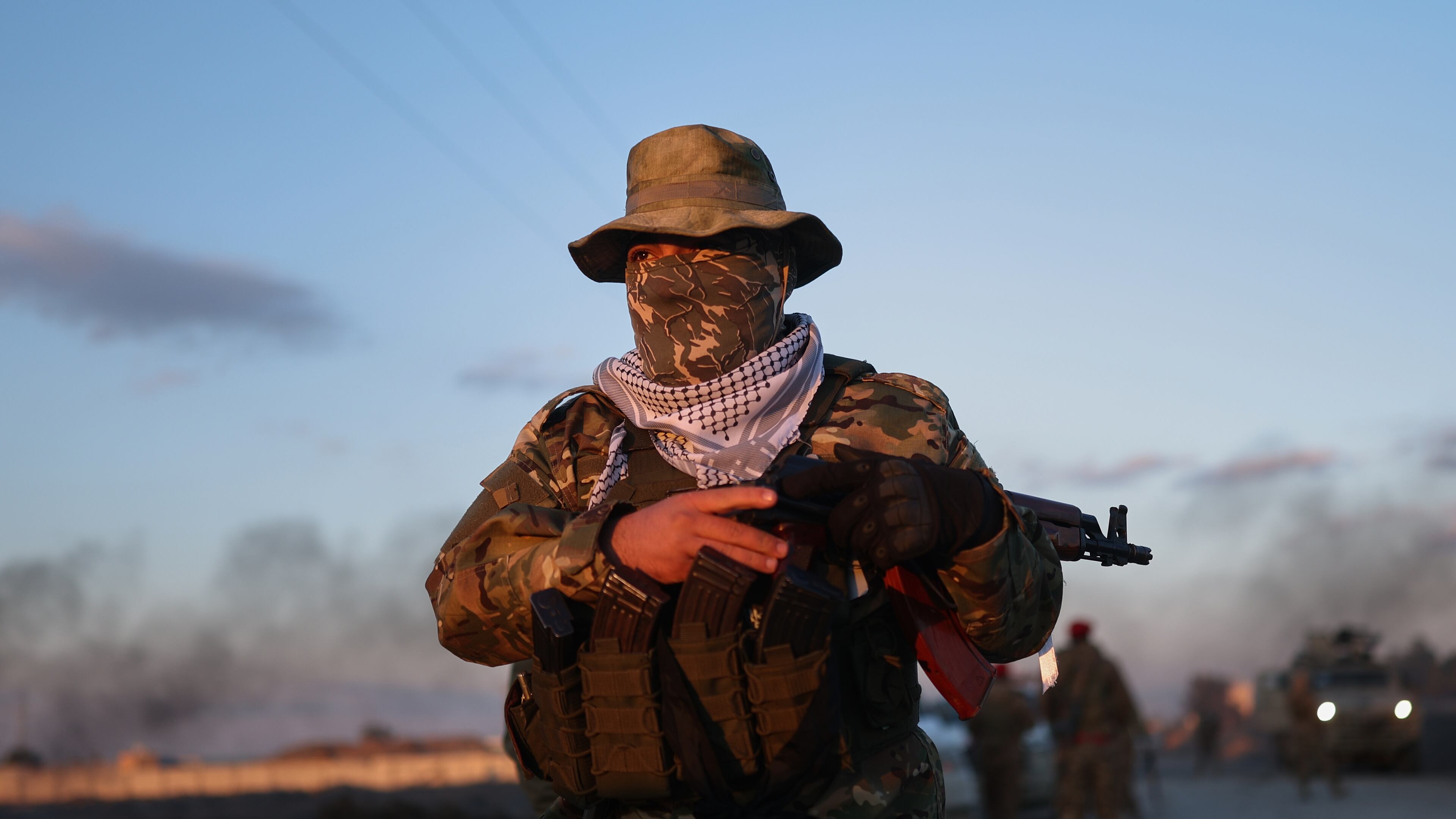 A Syrian government fighter stands guard outside Al-Aqtan prison on the outskirts of Raqqa, northeastern Syria, Monday, Jan. 19, 2026, as negotiations are underway with the Kurdish-led Syrian Democratic Forces over a withdrawal from the prison. (AP Photo/Ghaith Alsayed)