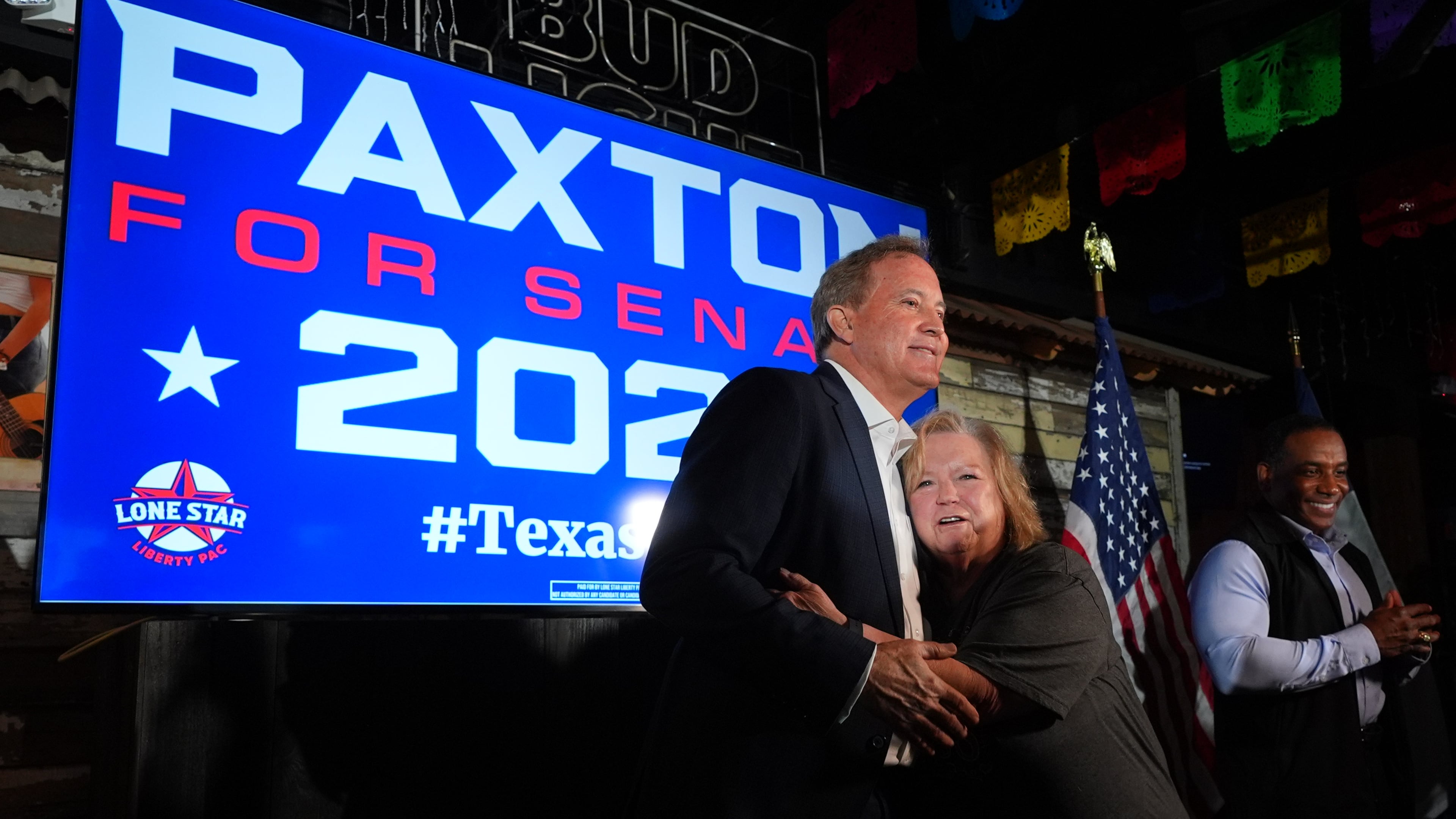 Vickie Palmer, right, hugs Texas Attorney General Ken Paxton, a Republican candidate for the U.S. Senate, at a campaign event in McKinney, Texas, Tuesday, May 19, 2026. (AP Photo/LM Otero)