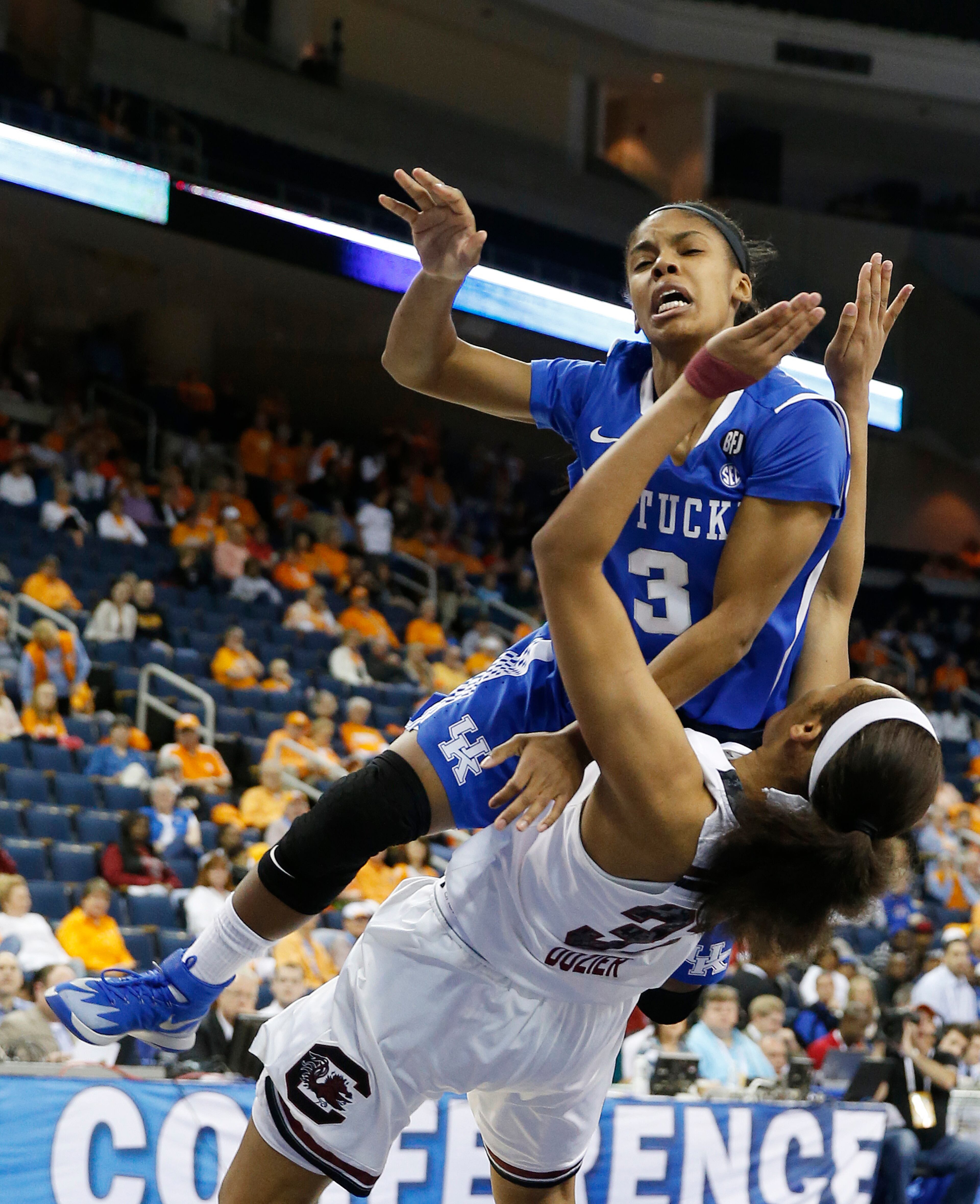 Kentucky guard Janee Thompson (3) collides with South Carolina guard/forward Asia Dozier (31) as she goes to the basket in the first half an NCAA college basketball game in the semifinals of the Southeastern Conference women's basketball tournament Saturday, March 8, 2014, in Duluth, Ga.