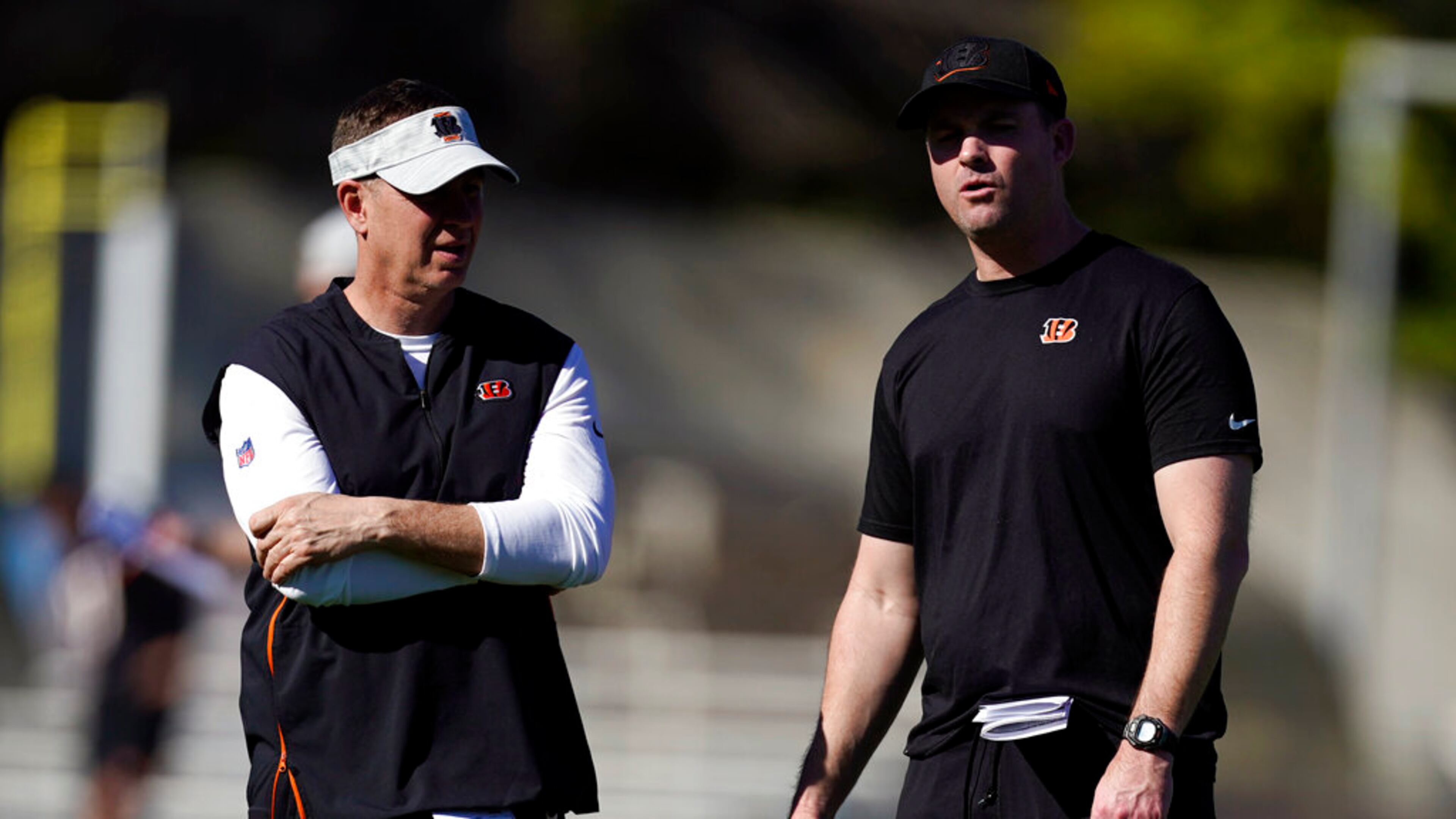 Cincinnati Bengals head coach Zac Taylor, right, talks to defensive coordinator Lou Anarumo during NFL football practice Wednesday, Feb. 9, 2022, in Los Angeles. The Cincinnati Bengals play the Los Angeles Rams in the Super Bowl Feb. 13. (AP Photo/Marcio Jose Sanchez)