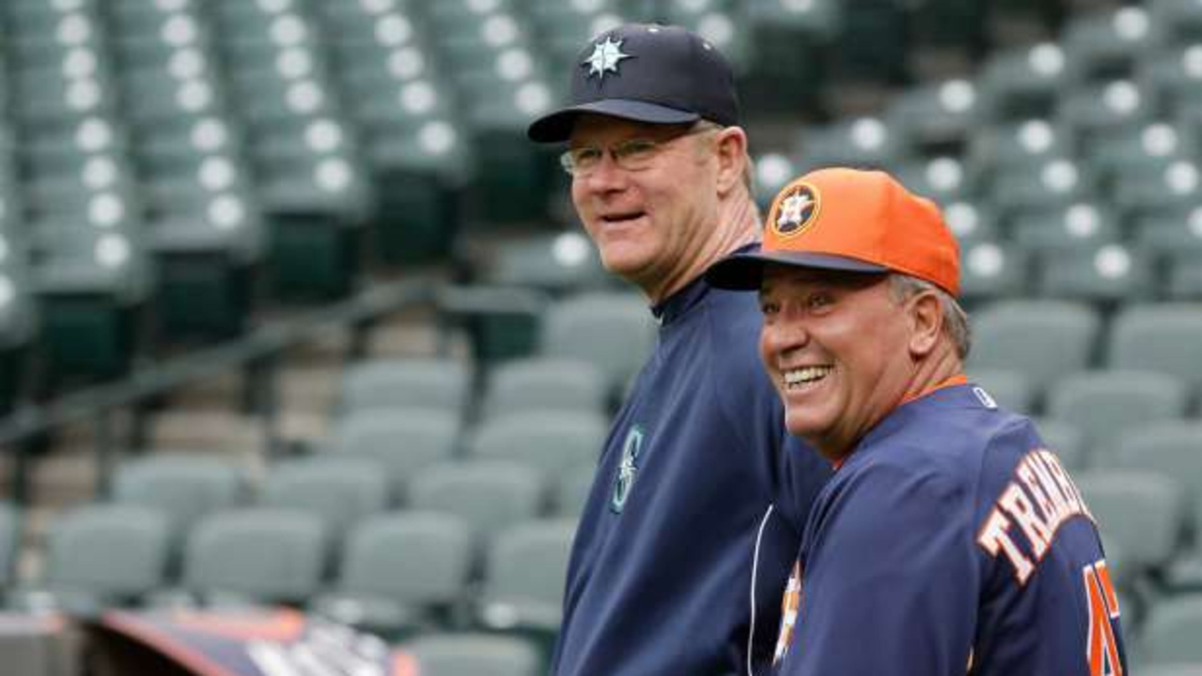 Third-base coaches Jeff Datz (left) of the Mariners and Dave Trembley of the Astros chat before a 2013 game. Datz is the Braves’ new roving catching instructor. Trembley has served as the Braves’ director of player development since October 2014.
