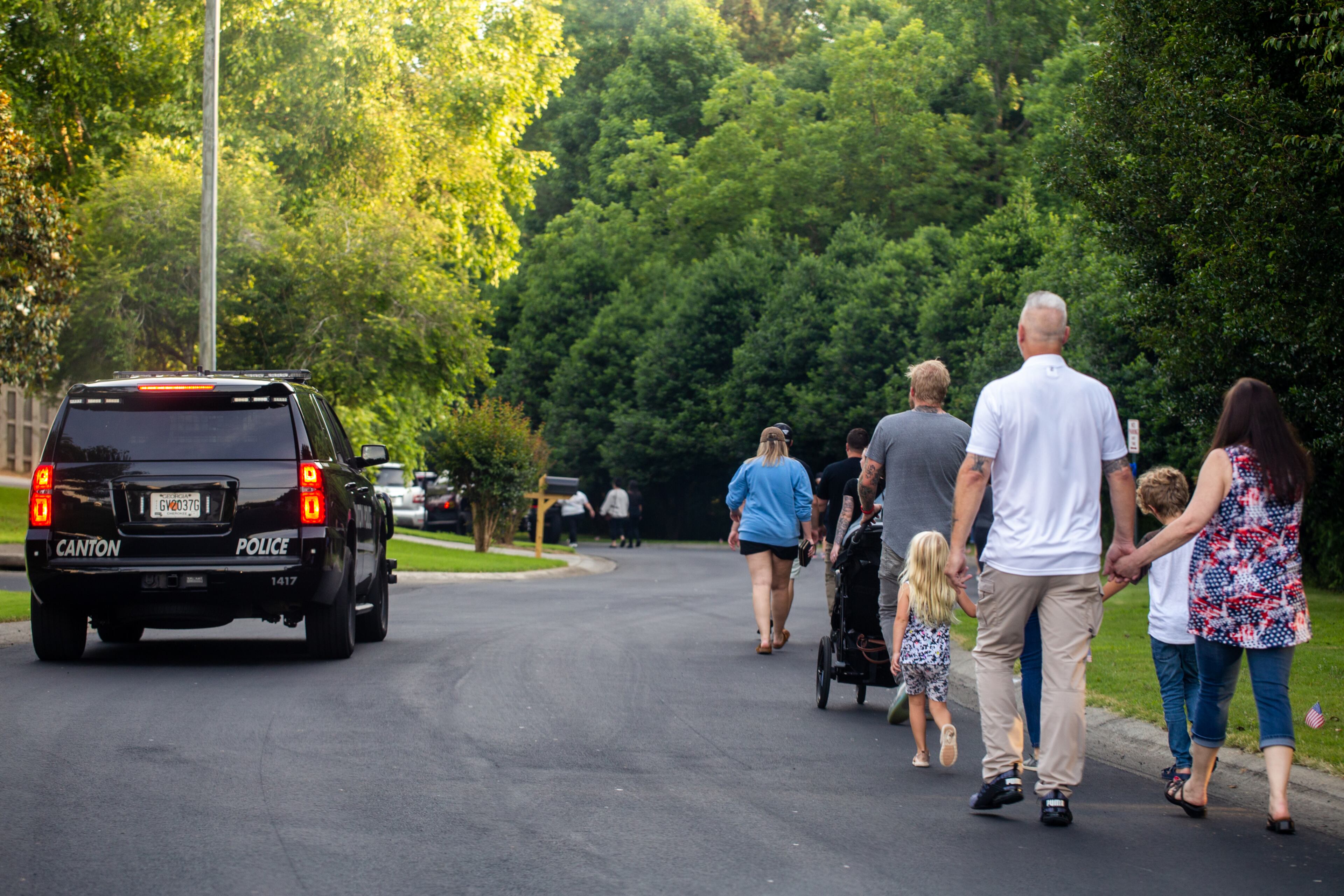 Members of the Holly Springs community and neighboring police departments gather at Barrett Park for a candlelight vigil for Police Officer Joe Burson on Friday, June 18, 2021 after he was killed during a traffic stop earlier this week.(Jenni Girtman for The Atlanta Journal-Constitution)