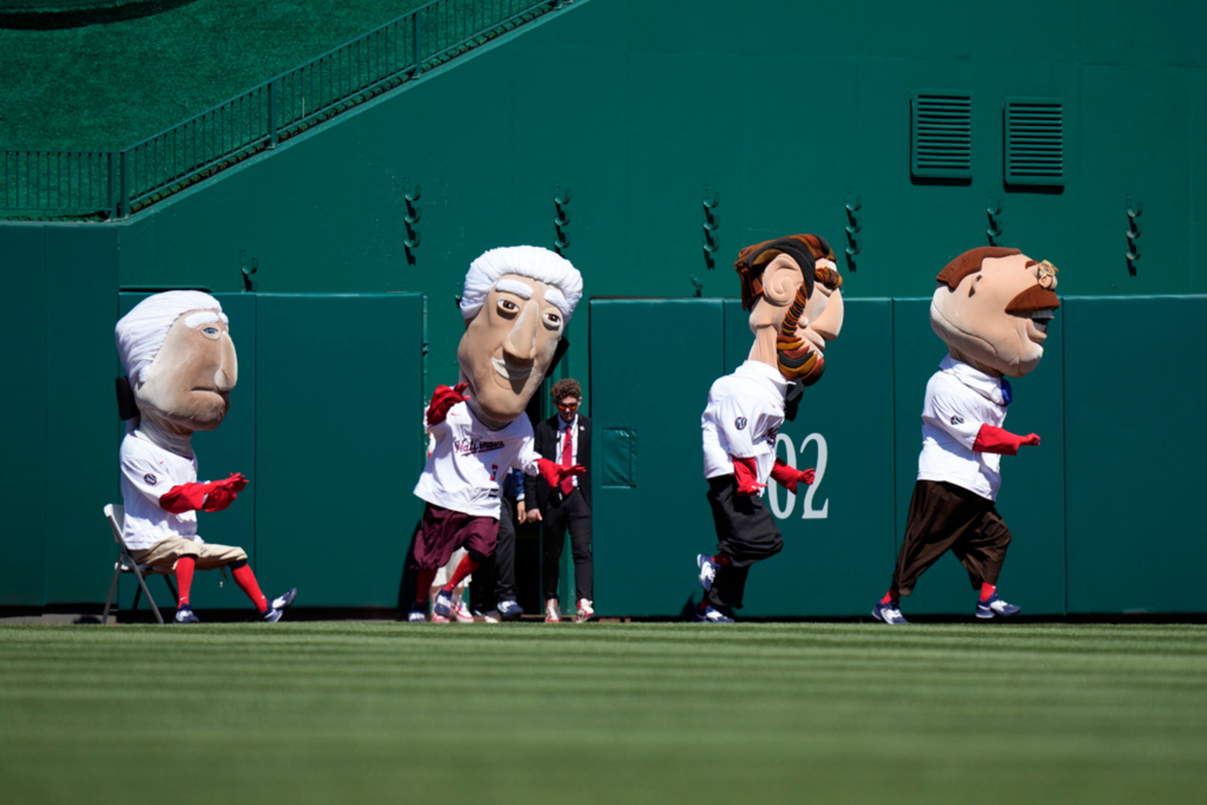 Members of the Washington Nationals' Racing Presidents participate in a race during an opening day baseball game between the Nationals and the Atlanta Braves at Nationals Park, Thursday, March 30, 2023, in Washington. (AP Photo/Alex Brandon)