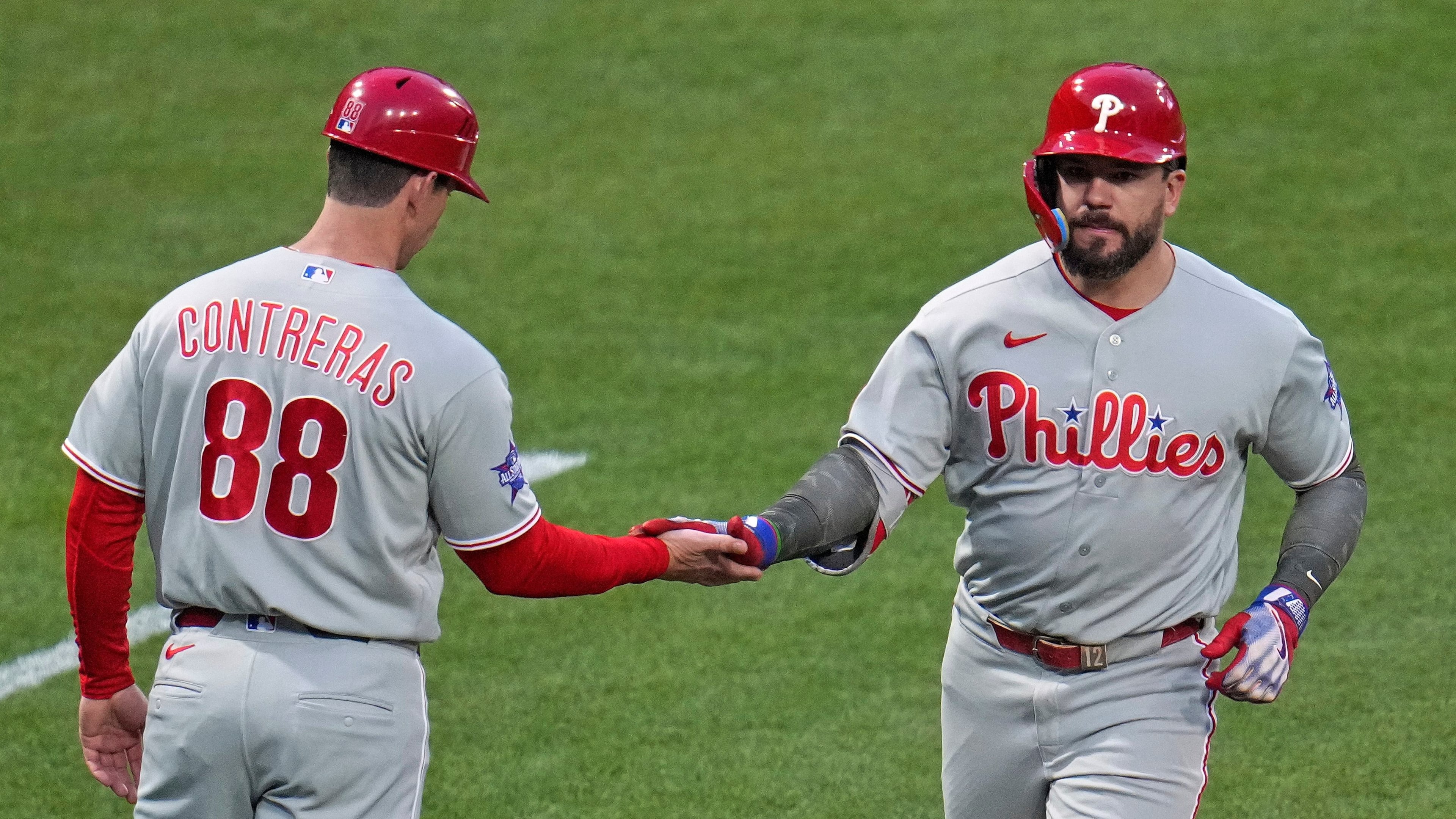 Philadelphia Phillies' Kyle Schwarber, right, rounds third base to greetings from third base coach Anth Contreras (88) after hitting a two-run home run off Pittsburgh Pirates pitcher Braxton Ashcraft during the fifth inning of a baseball game in Pittsburgh, Friday, May 15, 2026. (AP Photo/Gene J. Puskar)
