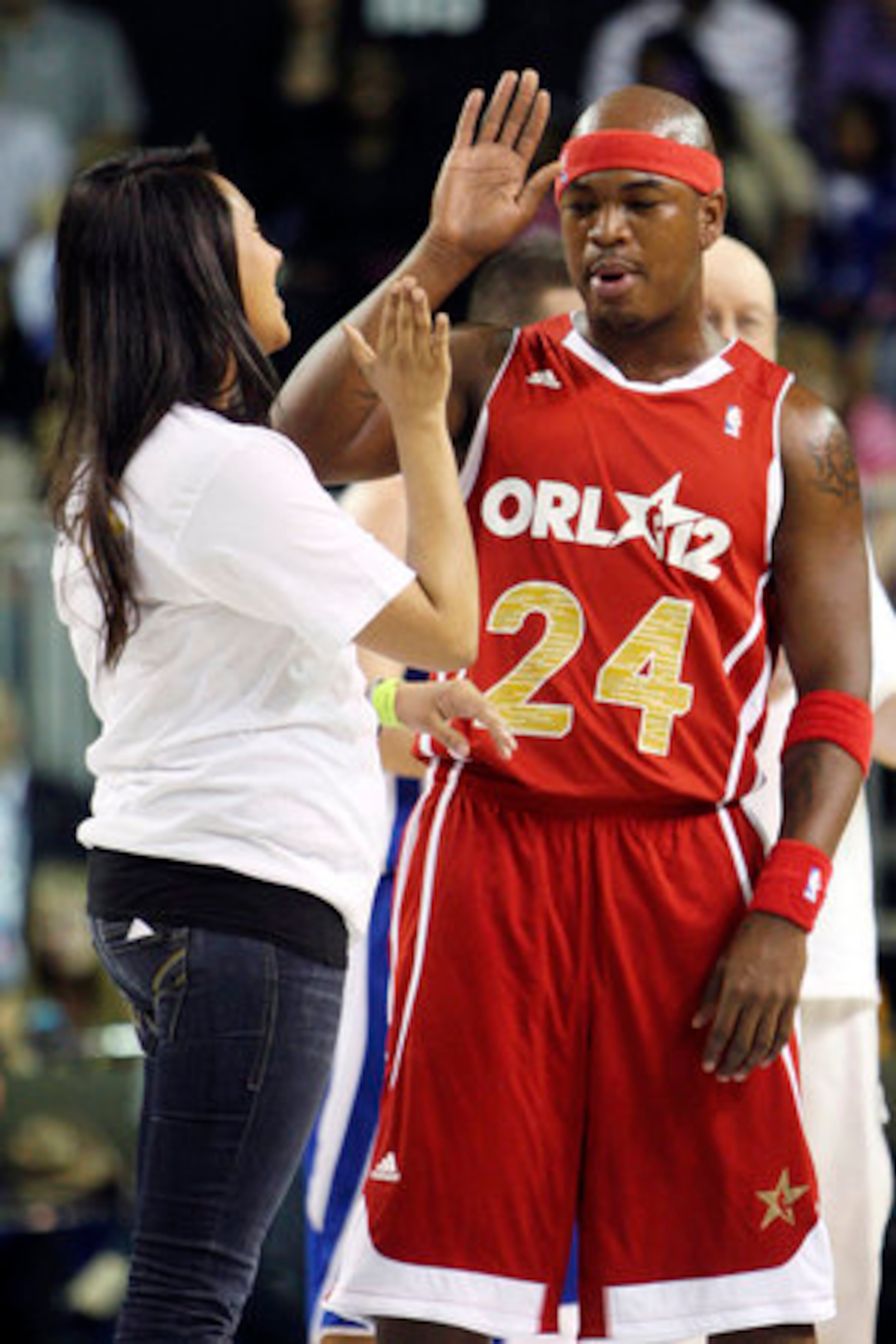 Rapper Ne-Yo showed off some dance moves as well as basketball style. He high-fives a contestant in a dance contest.