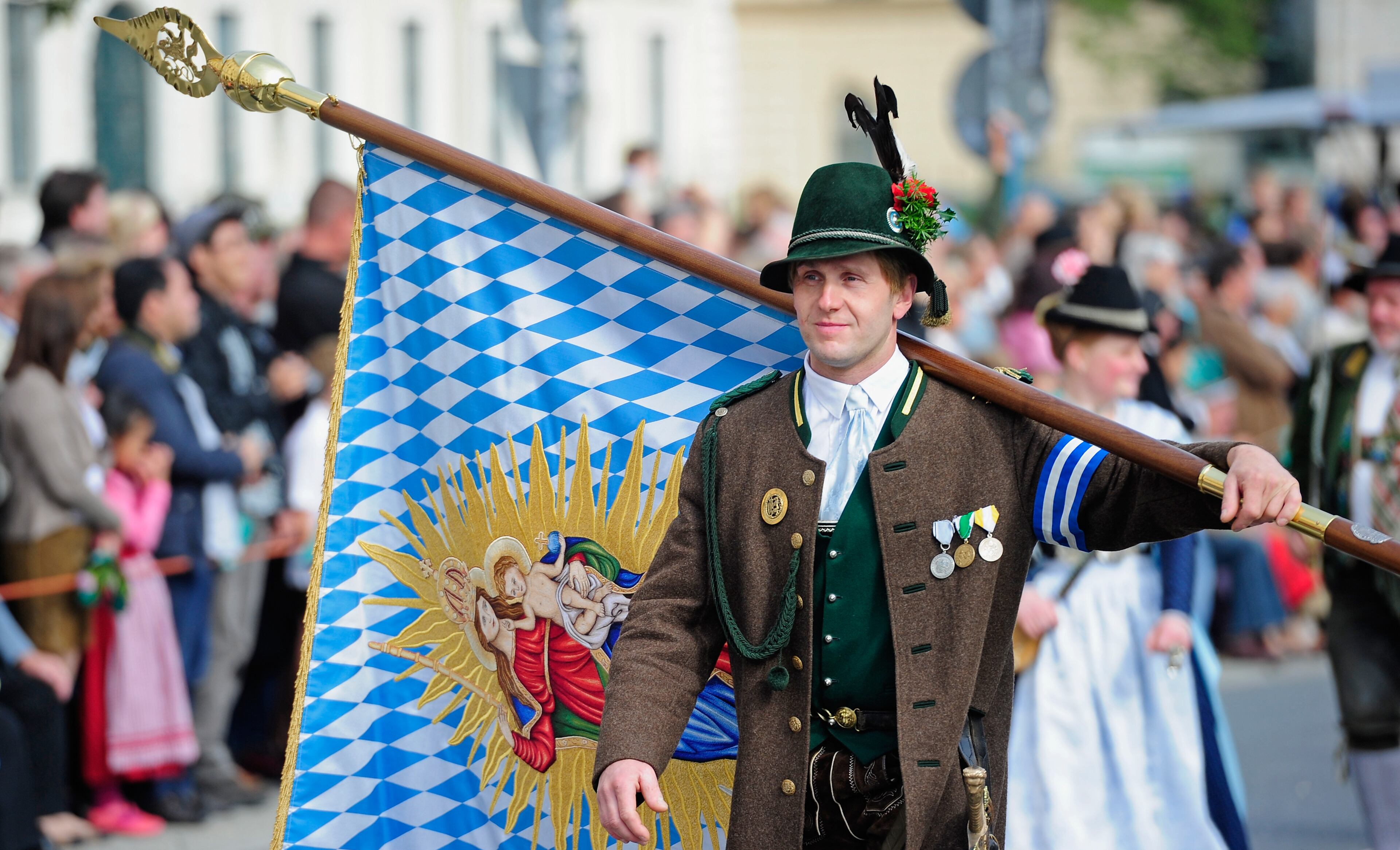 MUNICH, GERMANY - SEPTEMBER 22: Member of costume group dressed in traditional bavarian clothes participate in the opening parade of the Oktoberfest 2013 beer festival at Odeonsplatz on September 22, 2013 in Munich, Germany. The Munich Oktoberfest, which this year will run from September 21 through October 6, is the world's largest beer fest and draws millions of visitors. (Photo by Lennart Preiss/Getty Images)