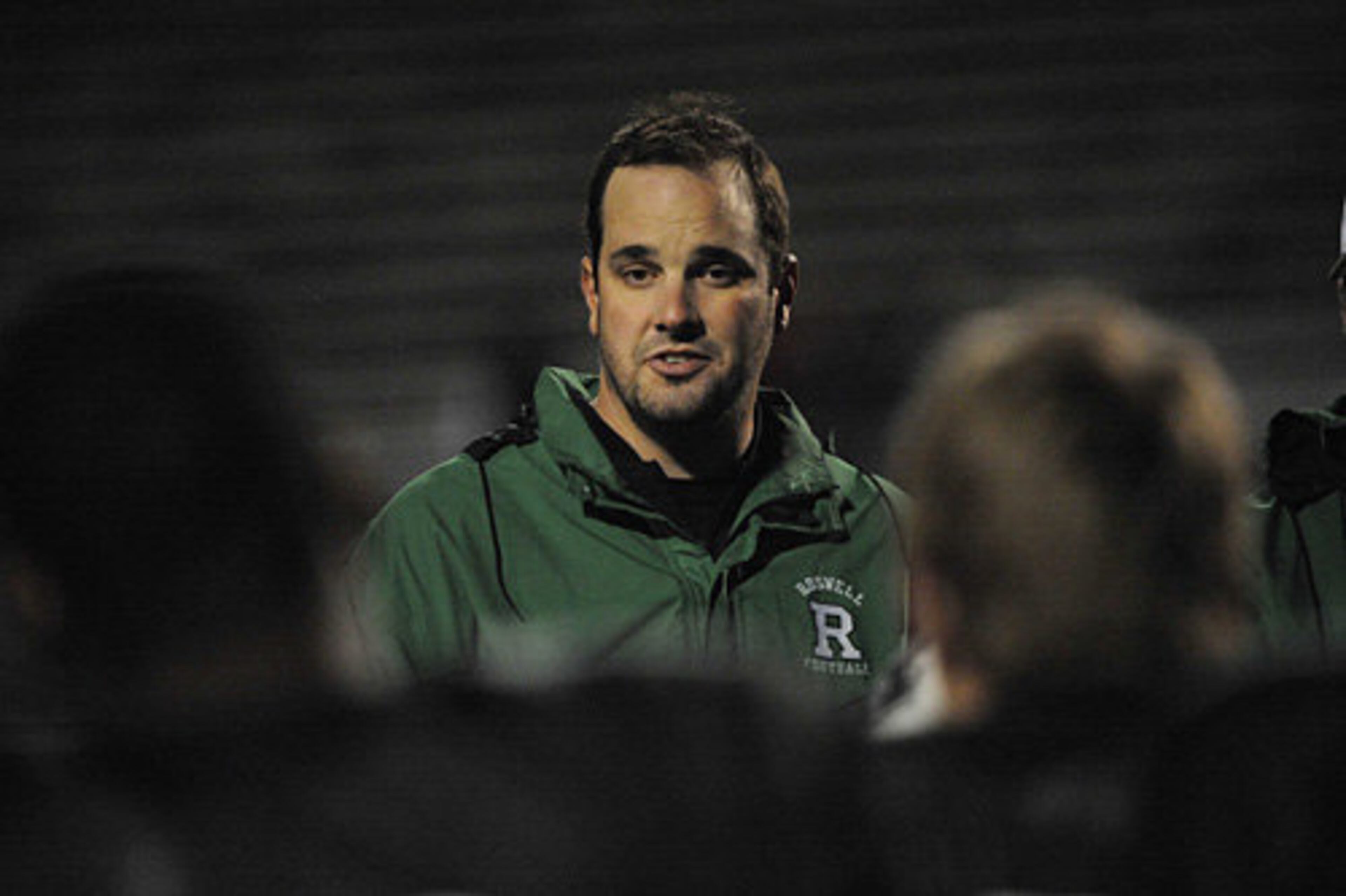 Roswell head coach Justin Sanderson talks to his players after losing to West Forsyth.