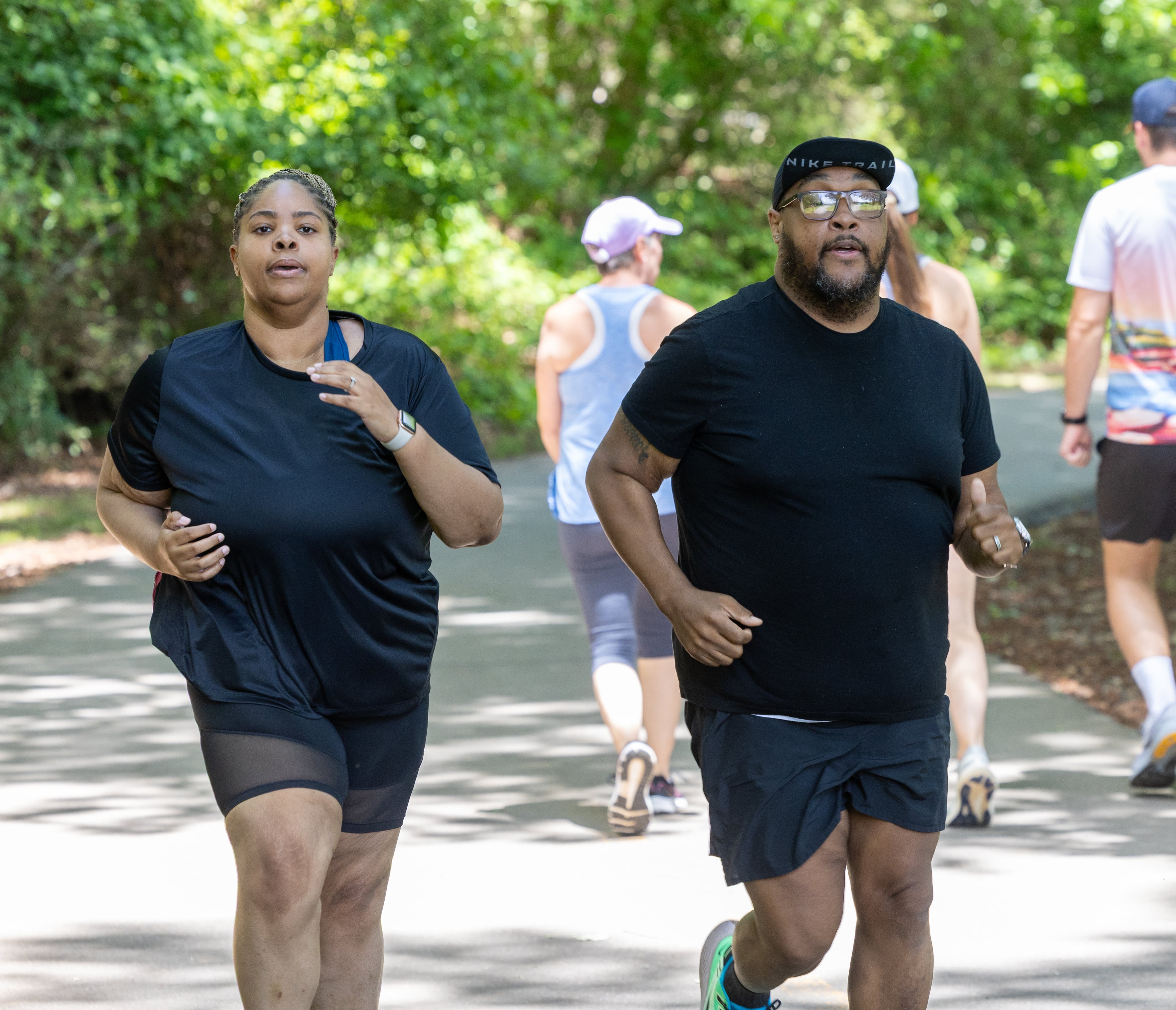 Christopher, 35, and Nicole Russell, 32, train for the Peachtree Road Race at Swift Cantrell Park in Kennesaw. (Phil Skinner for The Atlanta Journal-Constitution)