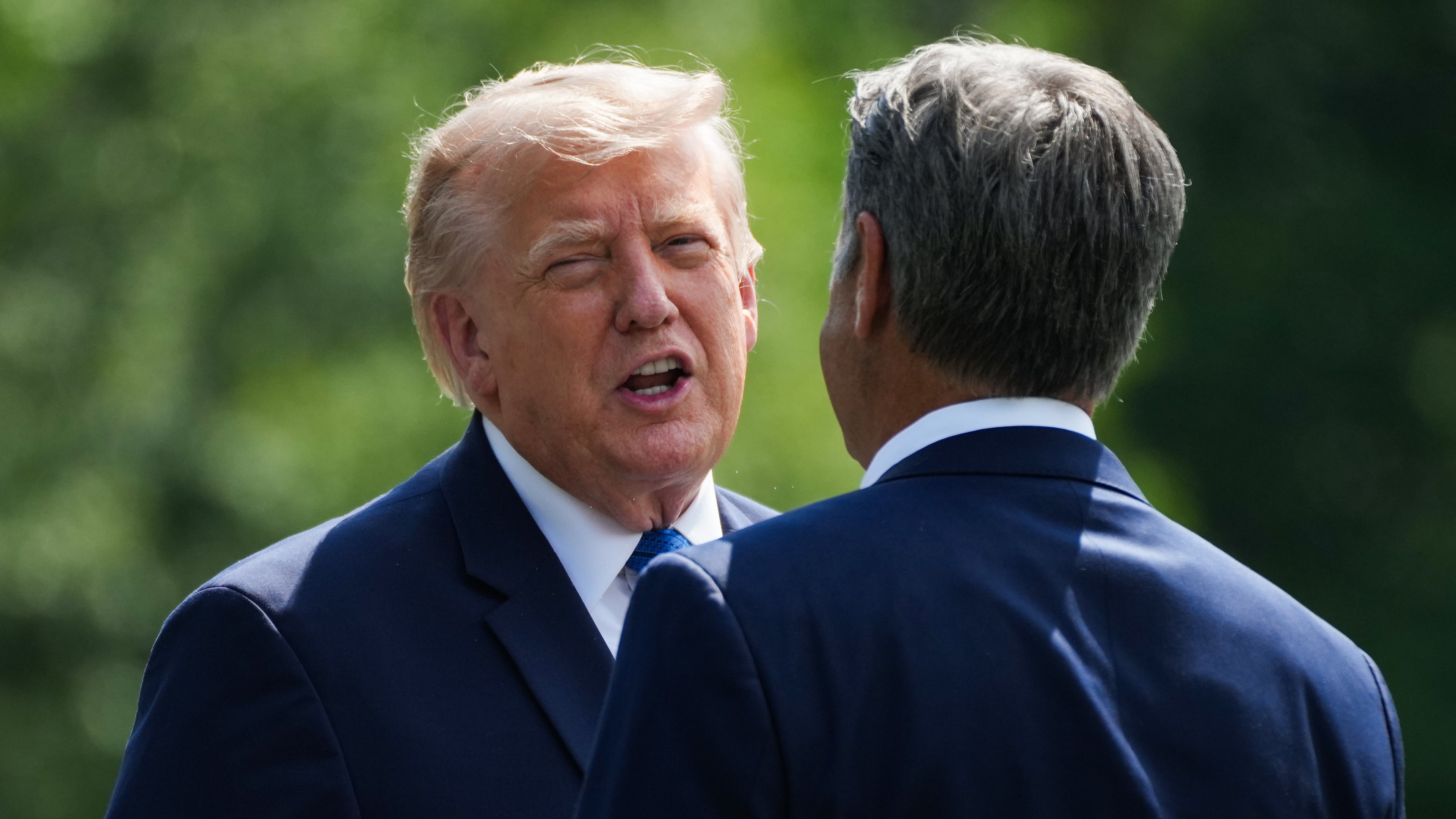 President Donald Trump, left, and CIA Director John Ratcliffe speak as they depart following a cabinet meeting at Camp David, near Thurmont, Md., Friday, July 31, 2026. (Nathan Howard/Pool Photo via AP)