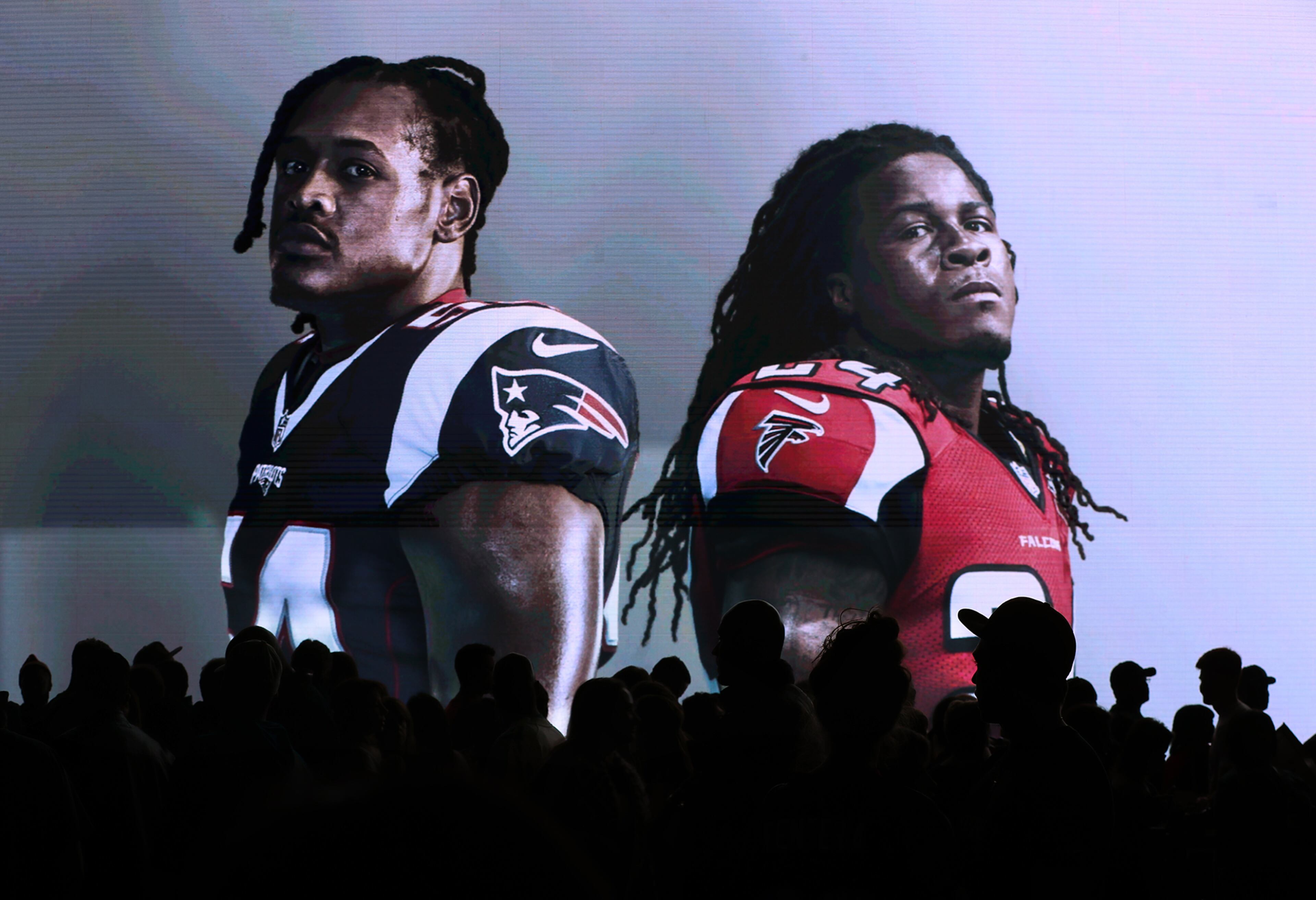 February 4, 2017, Houston: Thousands of fans pass by a giant screen projecting Patriots linebacker Dontâa Hightower and Falcons running back Devonta Freeman in the NFL Experience on Saturday Feb. 4, 2017, in Houston. Curtis Compton/ccompton@ajc.com