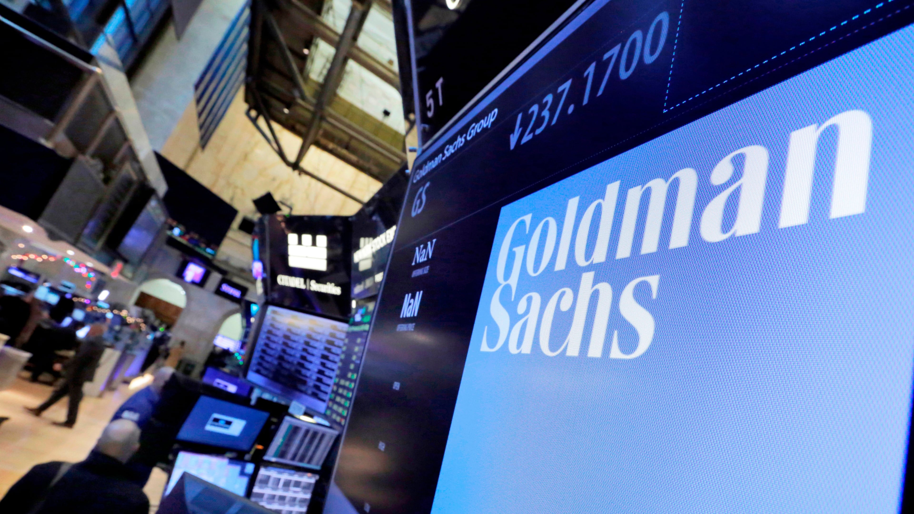 FILE - In this Dec. 13, 2016, file photo, the logo for Goldman Sachs appears above a trading post on the floor of the New York Stock Exchange. (AP Photo/Richard Drew, File)