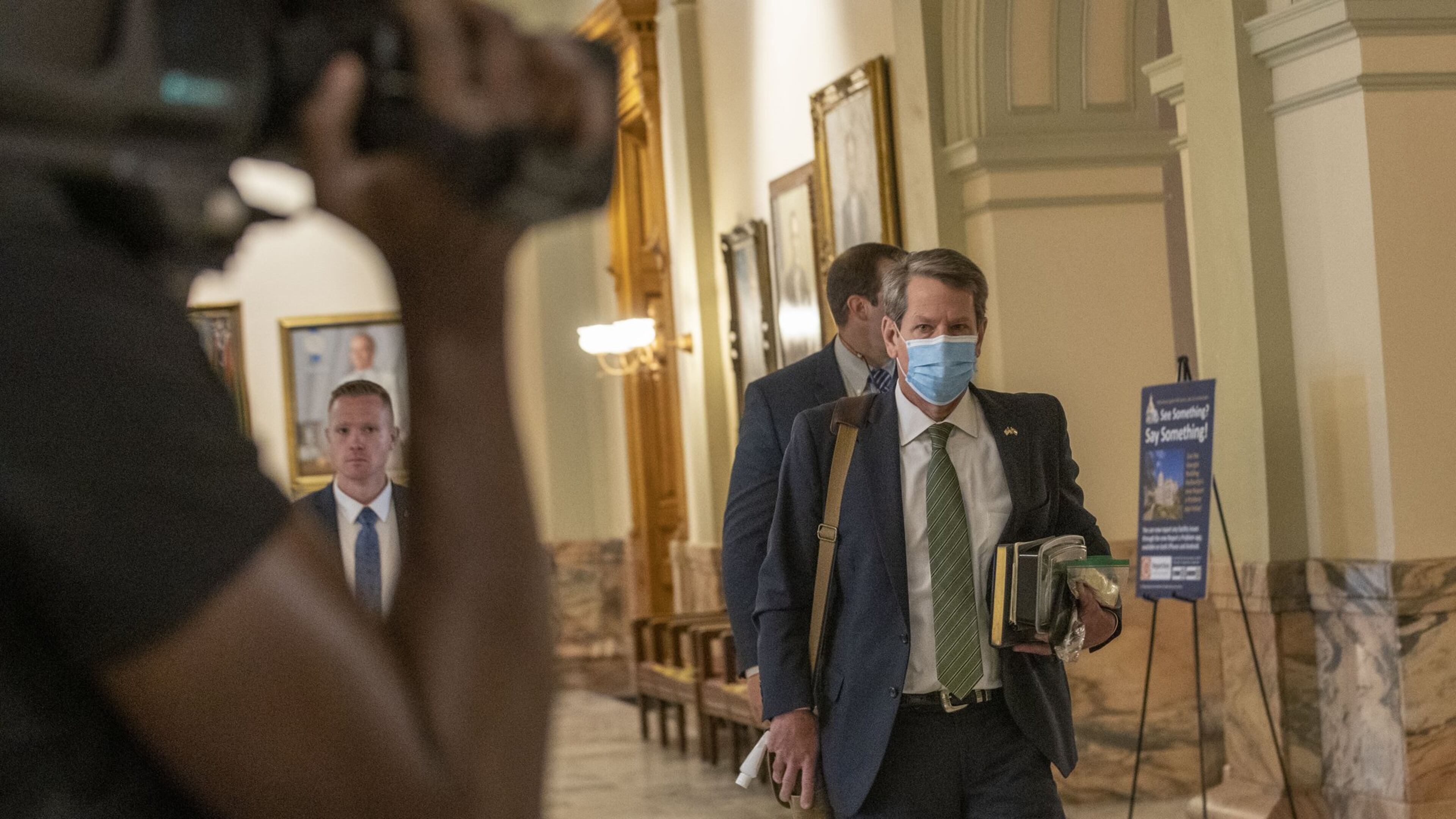 Gov. Brian Kemp arrives at the Georgia Capitol on Monday as members of the Legislature return to restart the legislative session that was suspended to stem the spread of COVID-19. (ALYSSA POINTER / ALYSSA.POINTER@AJC.COM)