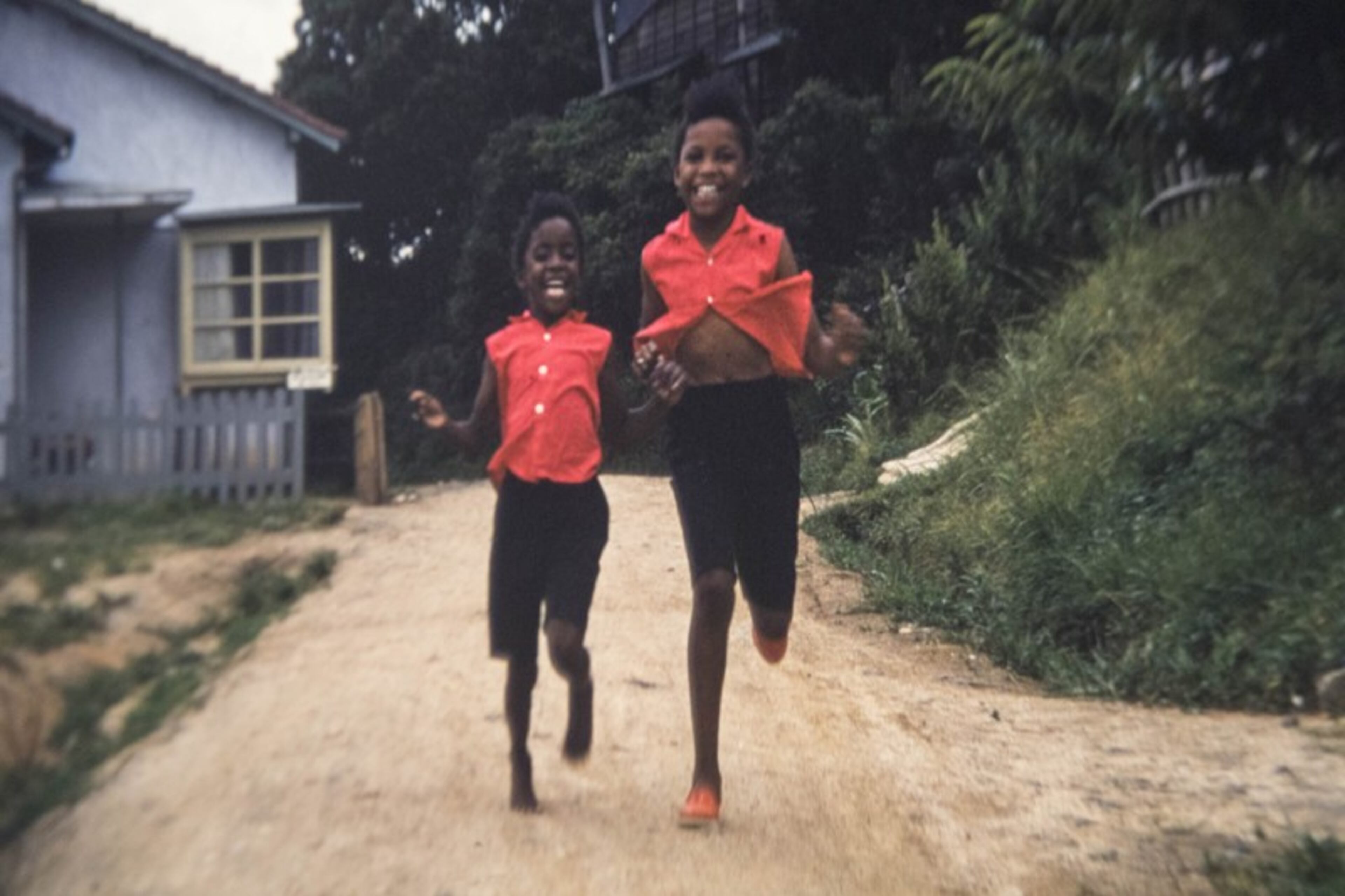 The little girls in the slides are always dressed alike, even when playing outside.