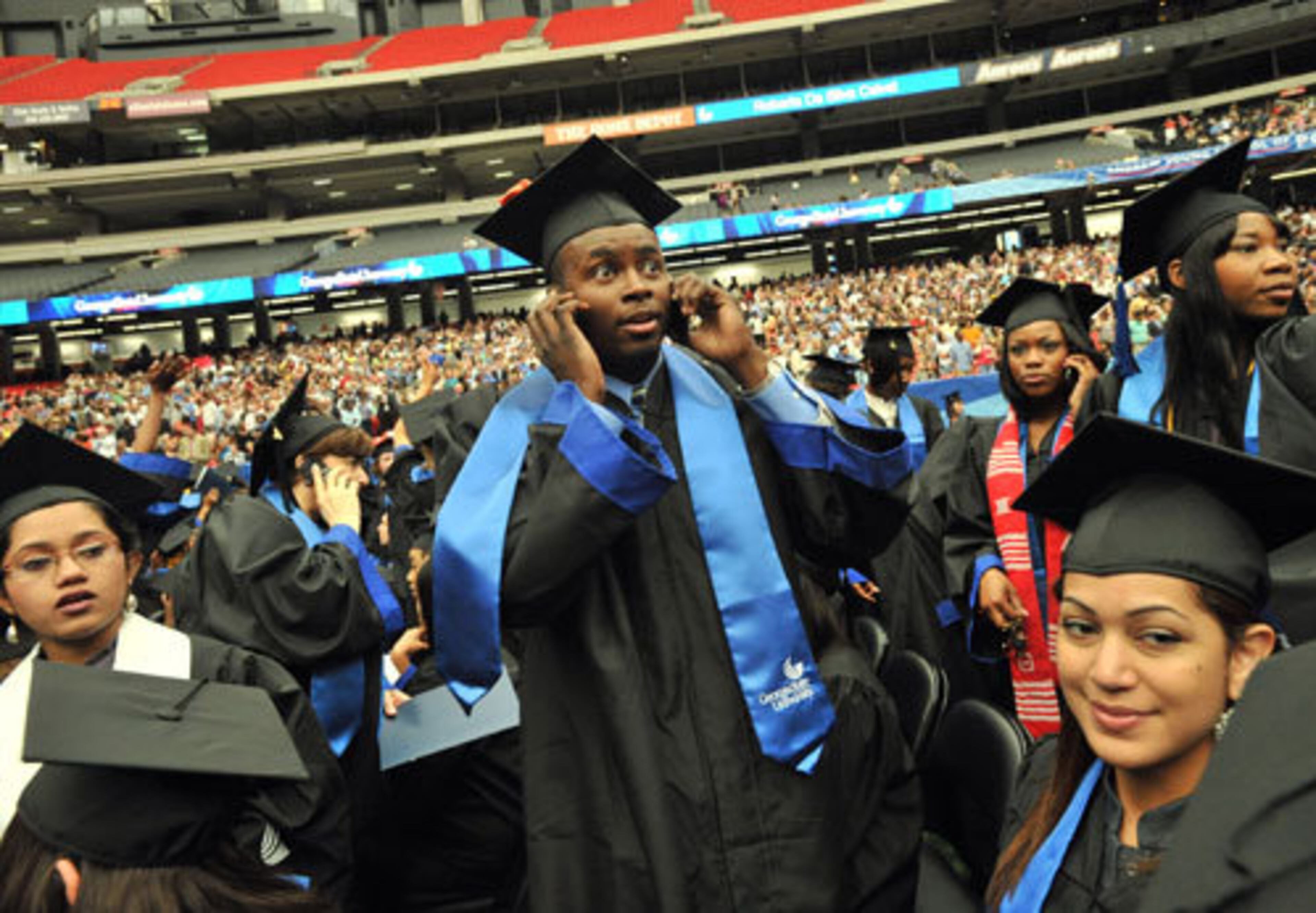 Marcus Somerville, Finance major, uses his cell phone to look for his family members.