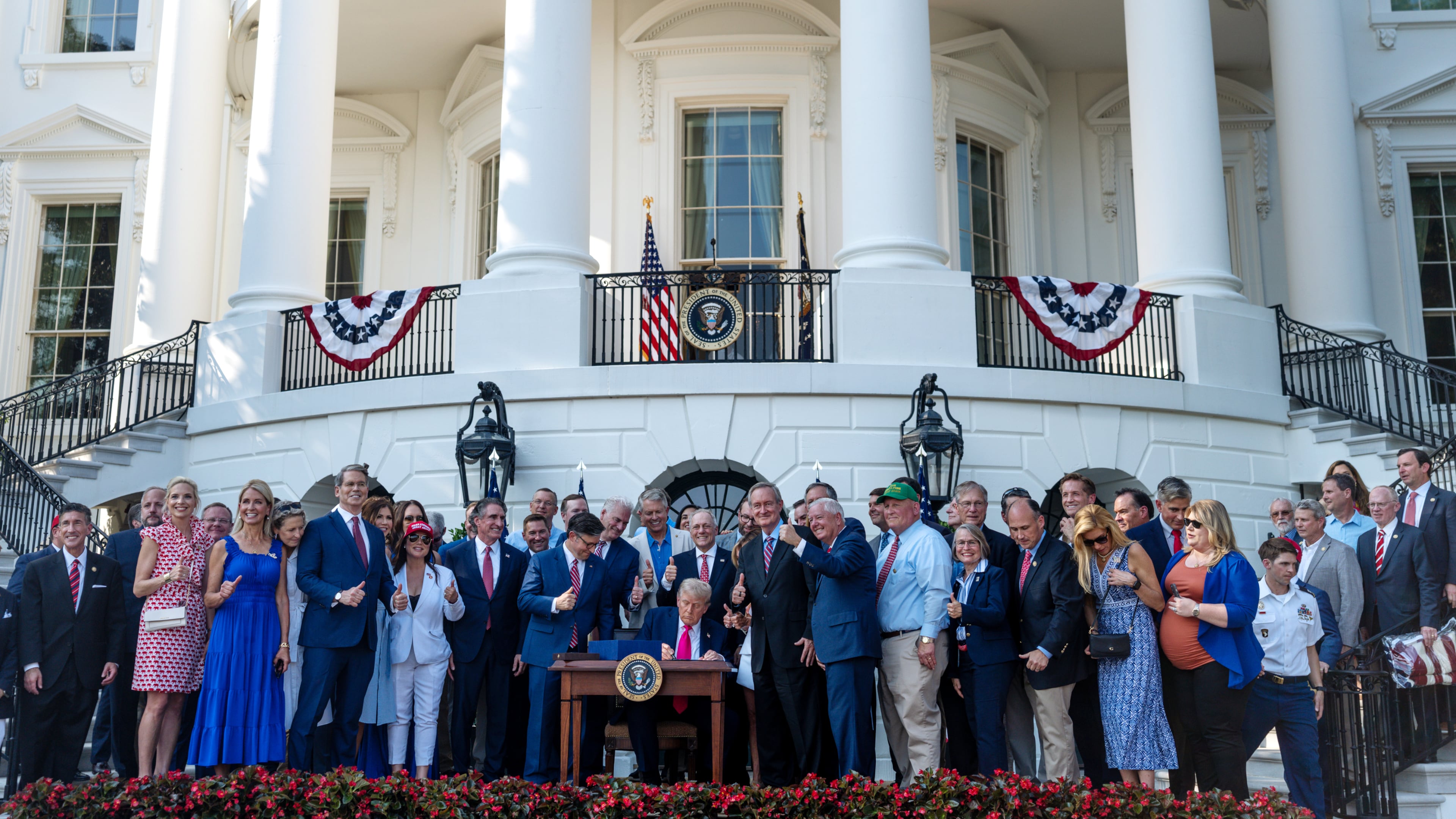 President Donald Trump signs the One Big Beautiful Bill Act into law during a Fourth of July celebration at the White House in Washington, July 4, 2025. (Tierney L. Cross/The New York Times)