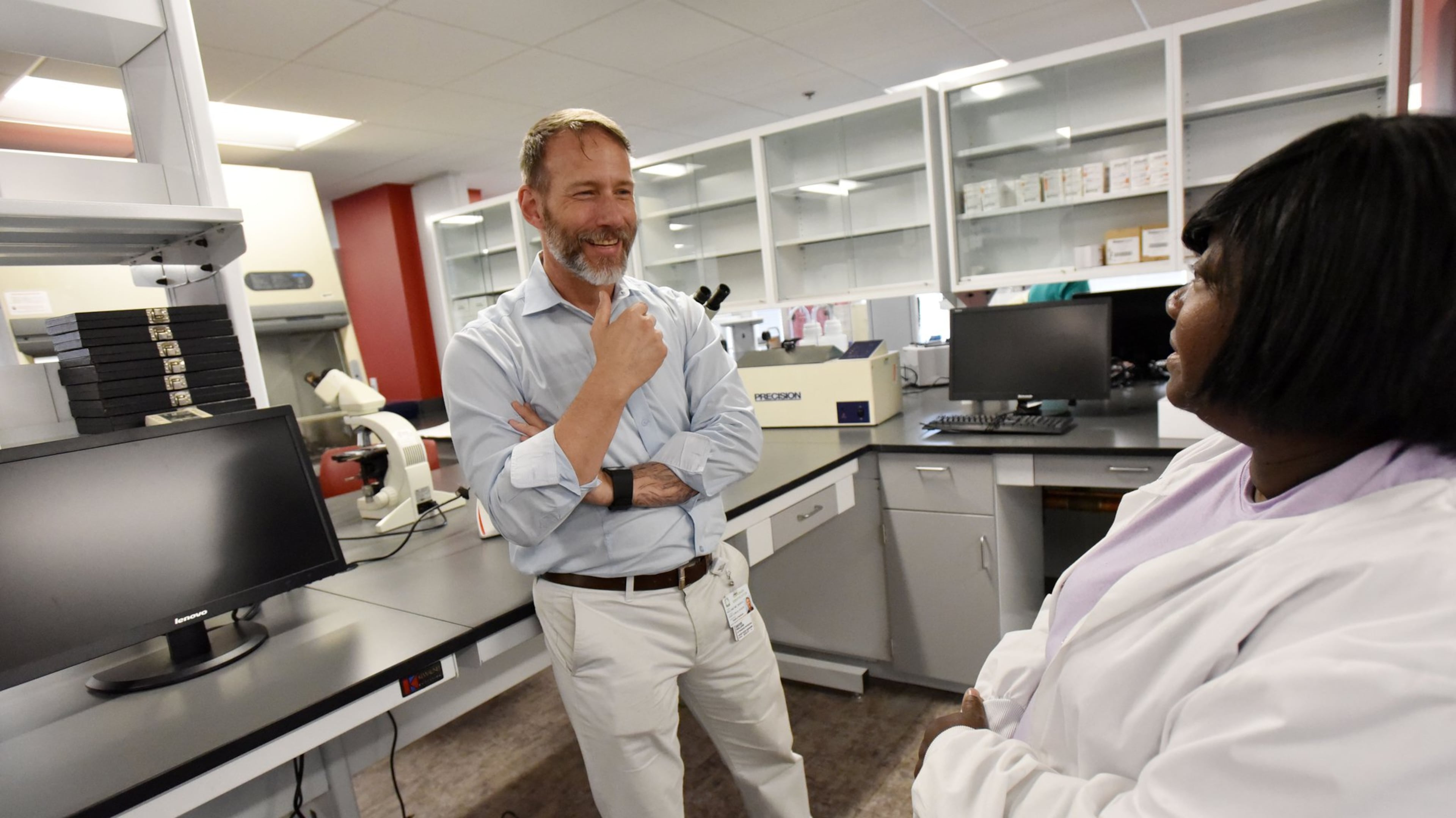 David Holland (left), Chief Clinical Officer, talks to Cassandra Marquette, Lab Director, in laboratory at new Fulton County Public Health Clinic on Tuesday, May 9, 2017. The newest Fulton County Health Center and district offices recently opened for patient and client services. Fulton County’s former flagship Aldredge Clinic is now operating as Fulton County Public Health at 10 Park Place South SE. HYOSUB SHIN / HSHIN@AJC.COM