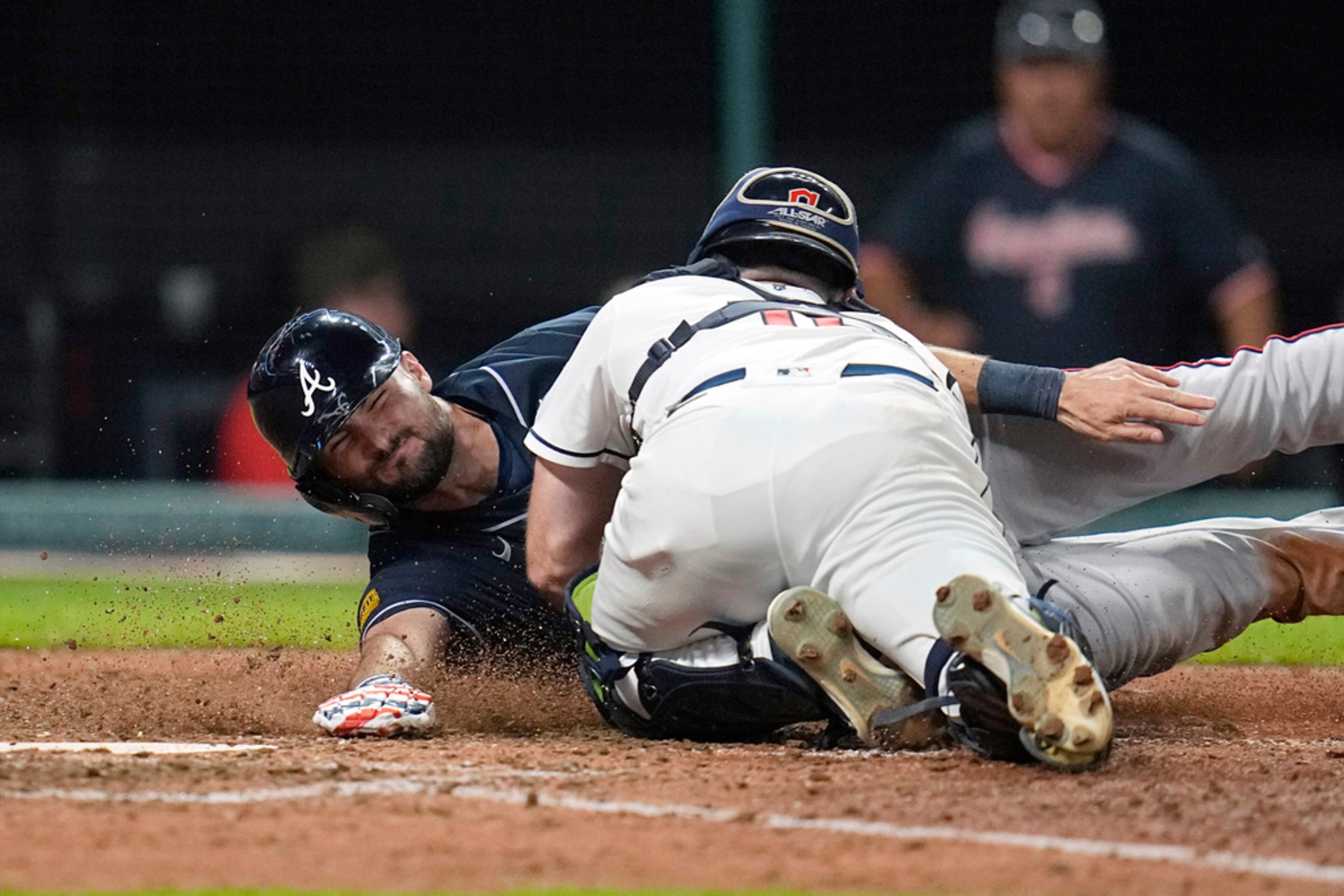Atlanta Braves' Sam Hilliard, left, is tagged out at home plate by Cleveland Guardians catcher David Fry in the tenth inning of a baseball game Tuesday, July 4, 2023, in Cleveland. The Braves lost 6-5. (AP Photo/Sue Ogrocki)