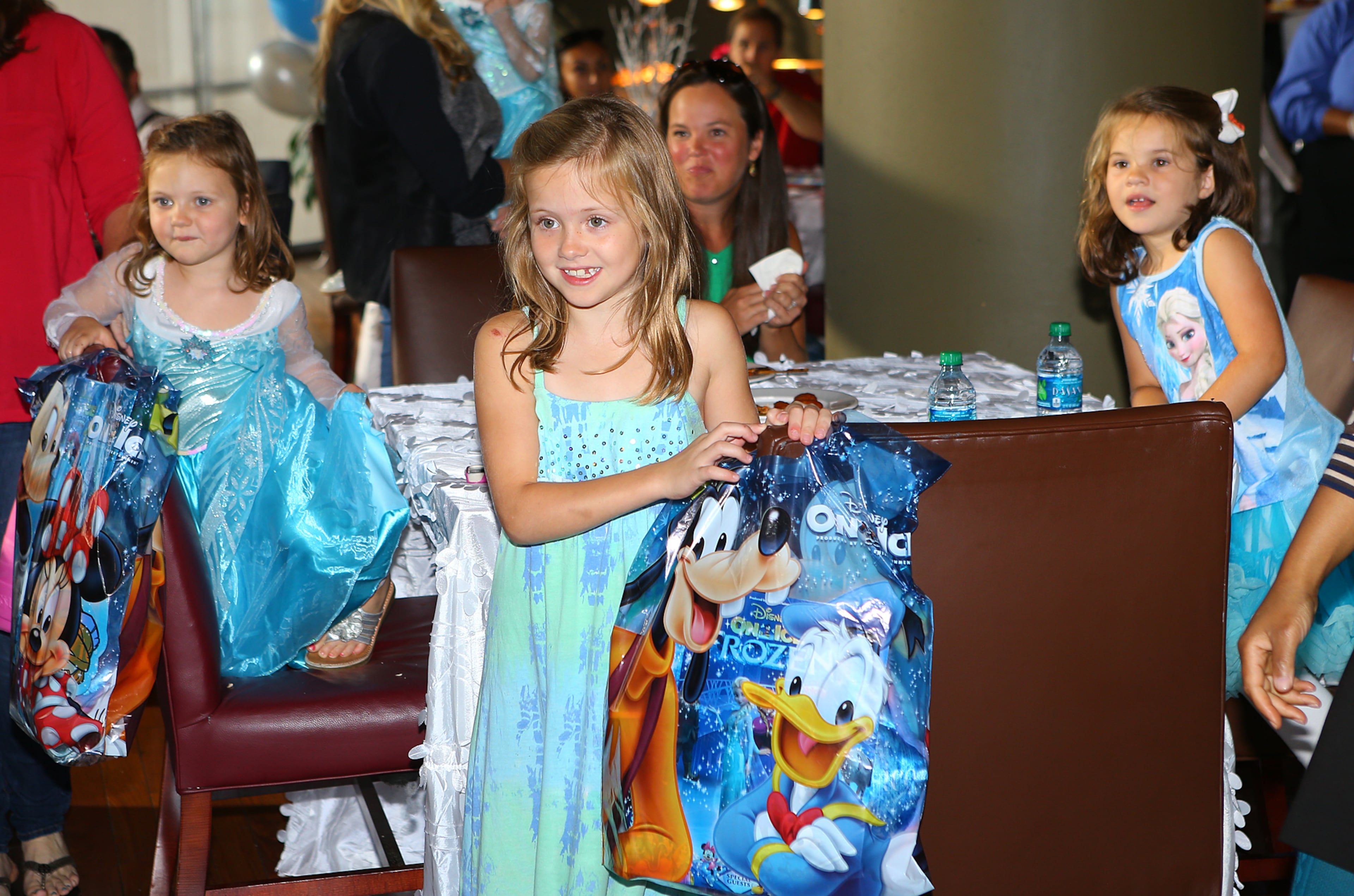 Little princesses look on and react as royal princess Anna arrives during the meet and greet for Disney On Ice presents Frozen at Philips Arena on Wednesday, Oct. 8, 2014, in Atlanta.