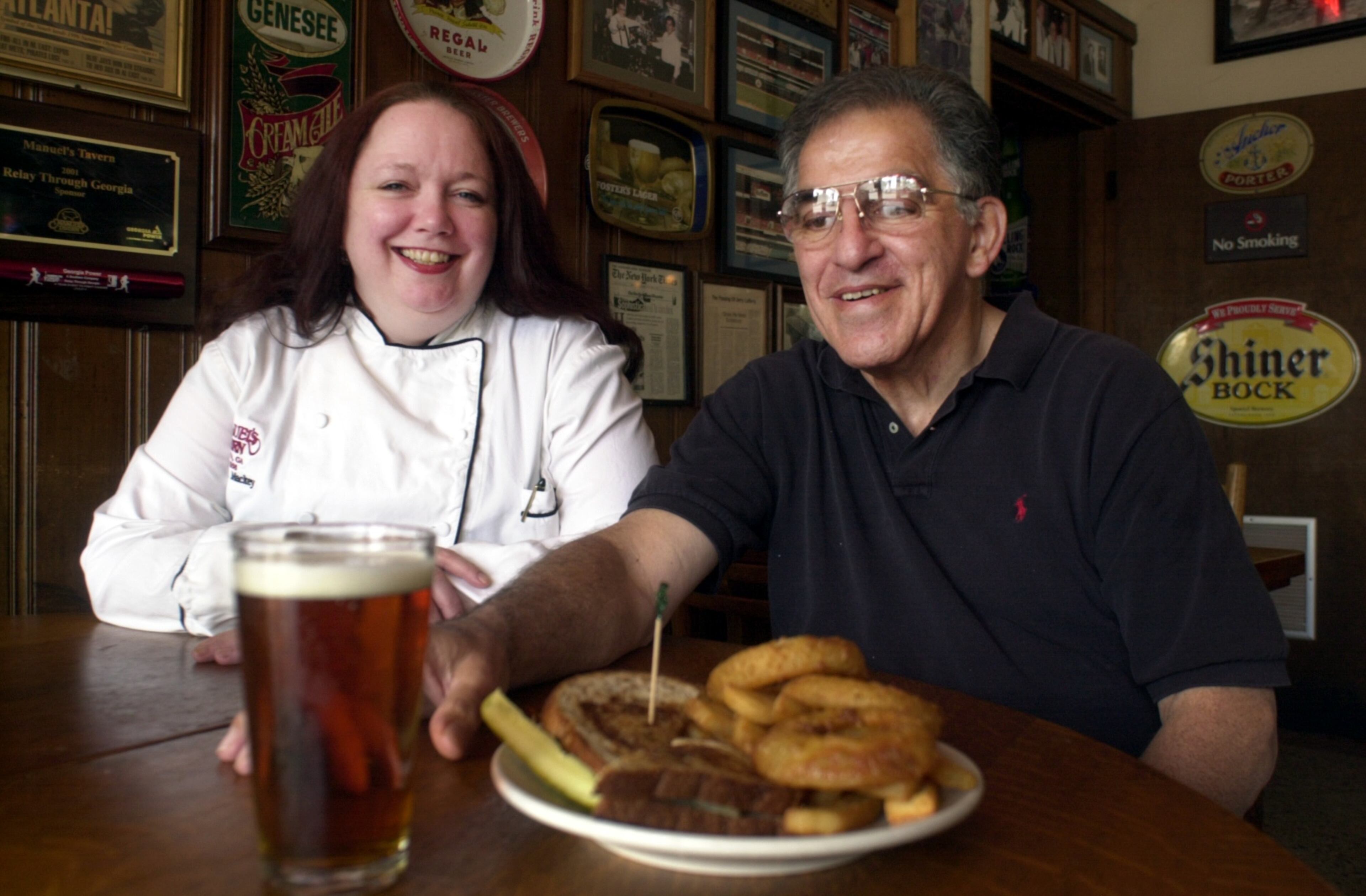 Chef Kathleen Mackey (left) and Robert Maloof in Manuel's Tavern October 2001. They're sitting with a J.J. Special and Killarney amber ale. (LOUIE FAVORITE/ STAFF)