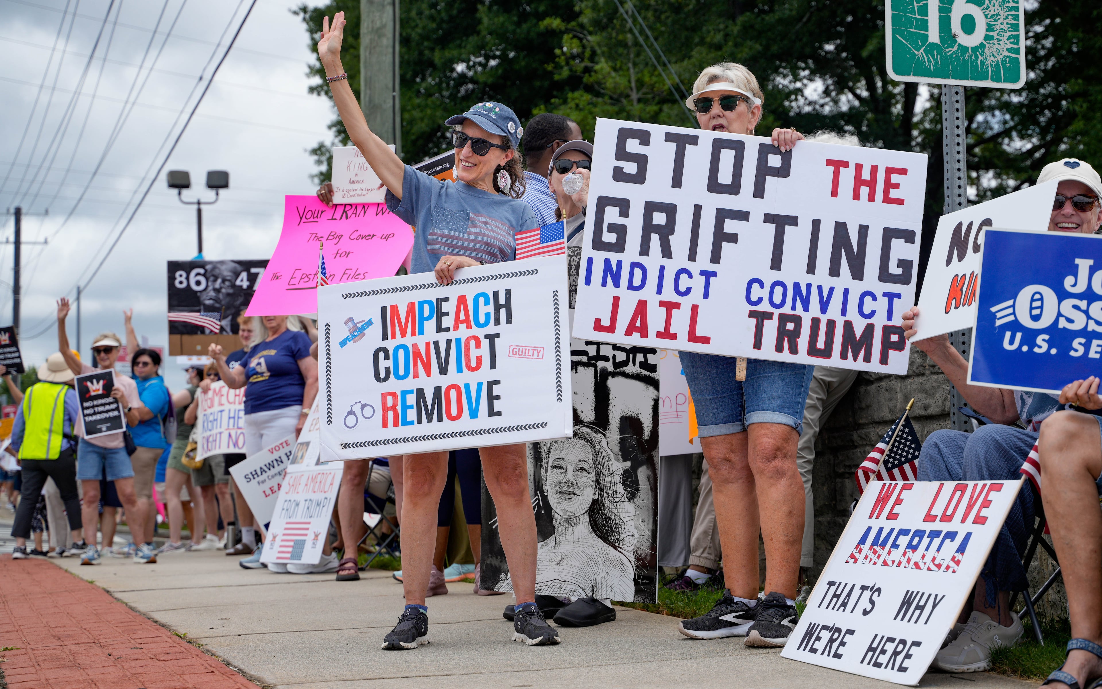 Protestors gather in Marietta while waiting for President Donald Trump to speak at Wheeler High School in Marietta on July 22, 2026. (Ben Hendren for the AJC)