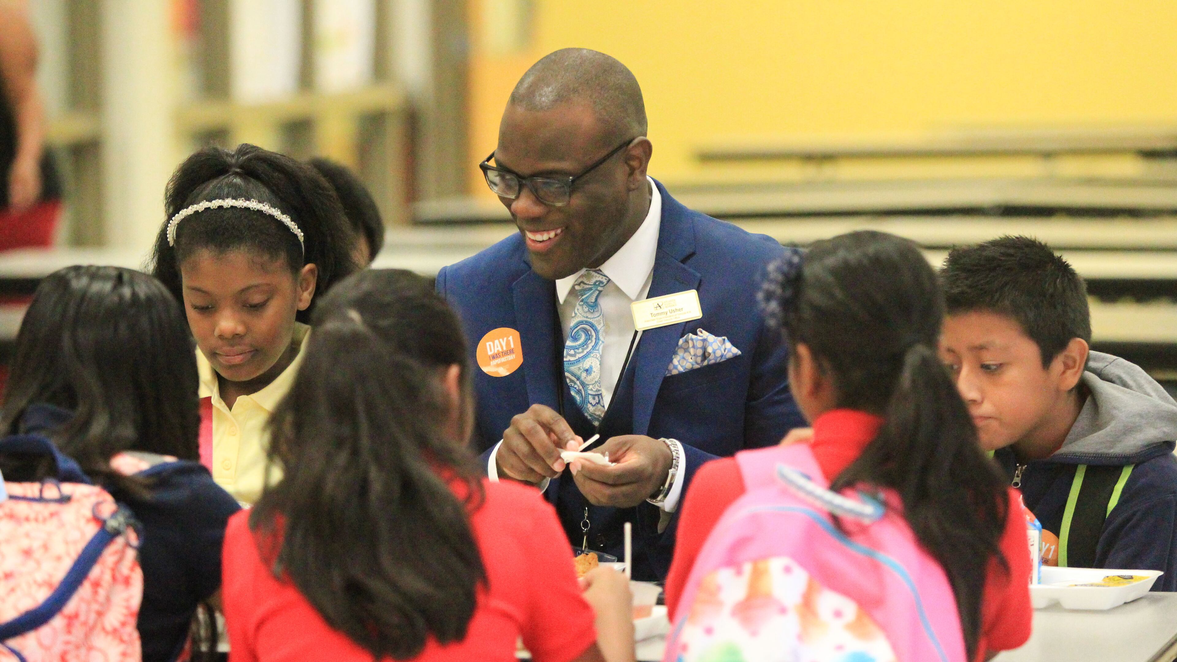 Tommy Usher, Atlanta Public Schools Associate Superintendent of Schools K-8 eats breakfast with Garden Hills Elementary School students before class starts in August. EMILY JENKINS/ EJENKINS@AJC.COM