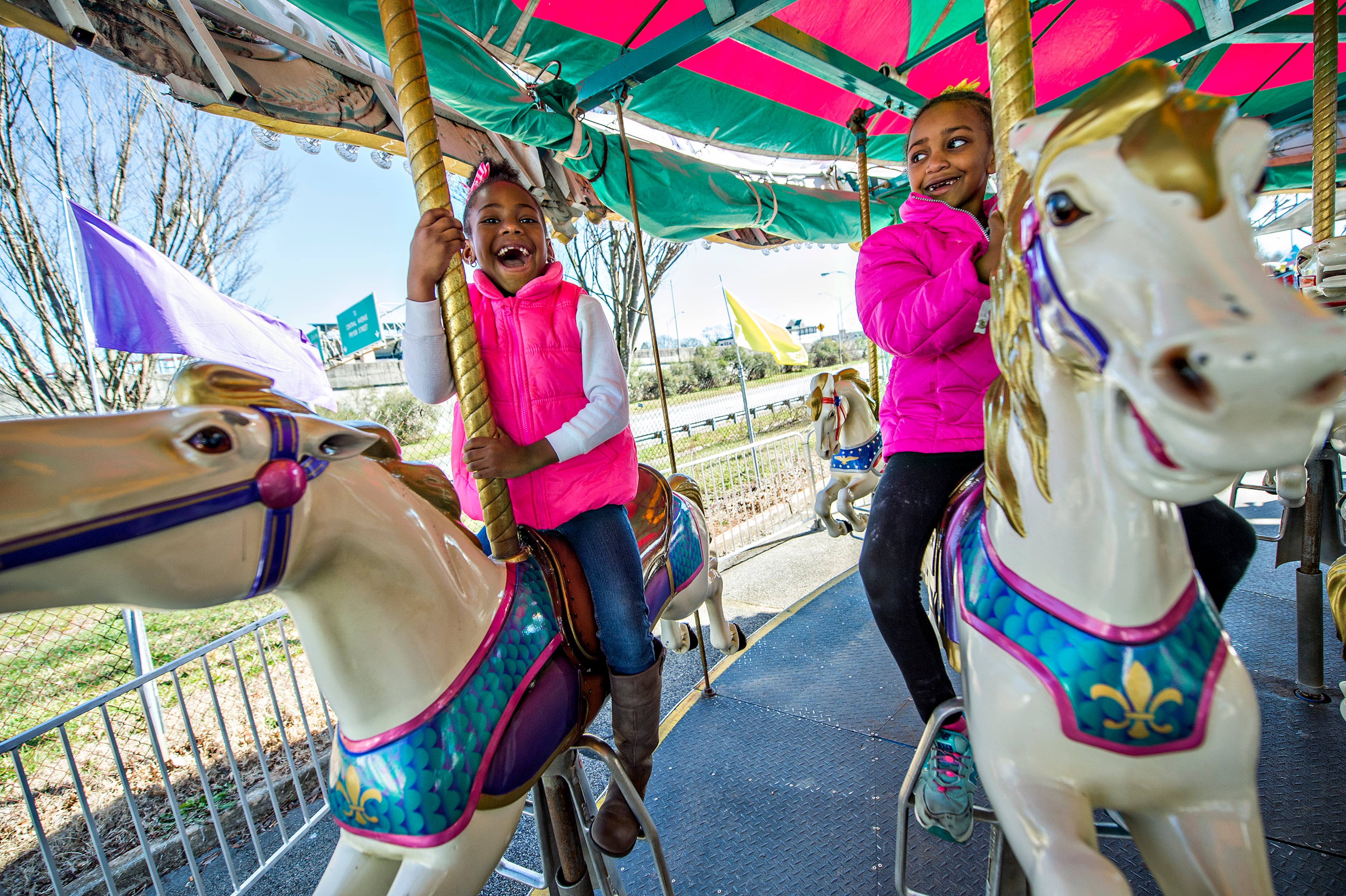Sky Brown (left) and Kennedy Barnett ride the merry-go-round at the Atlanta Fair near Turner Field on Saturday, Feb. 27, 2016. JONATHAN PHILLIPS / SPECIAL