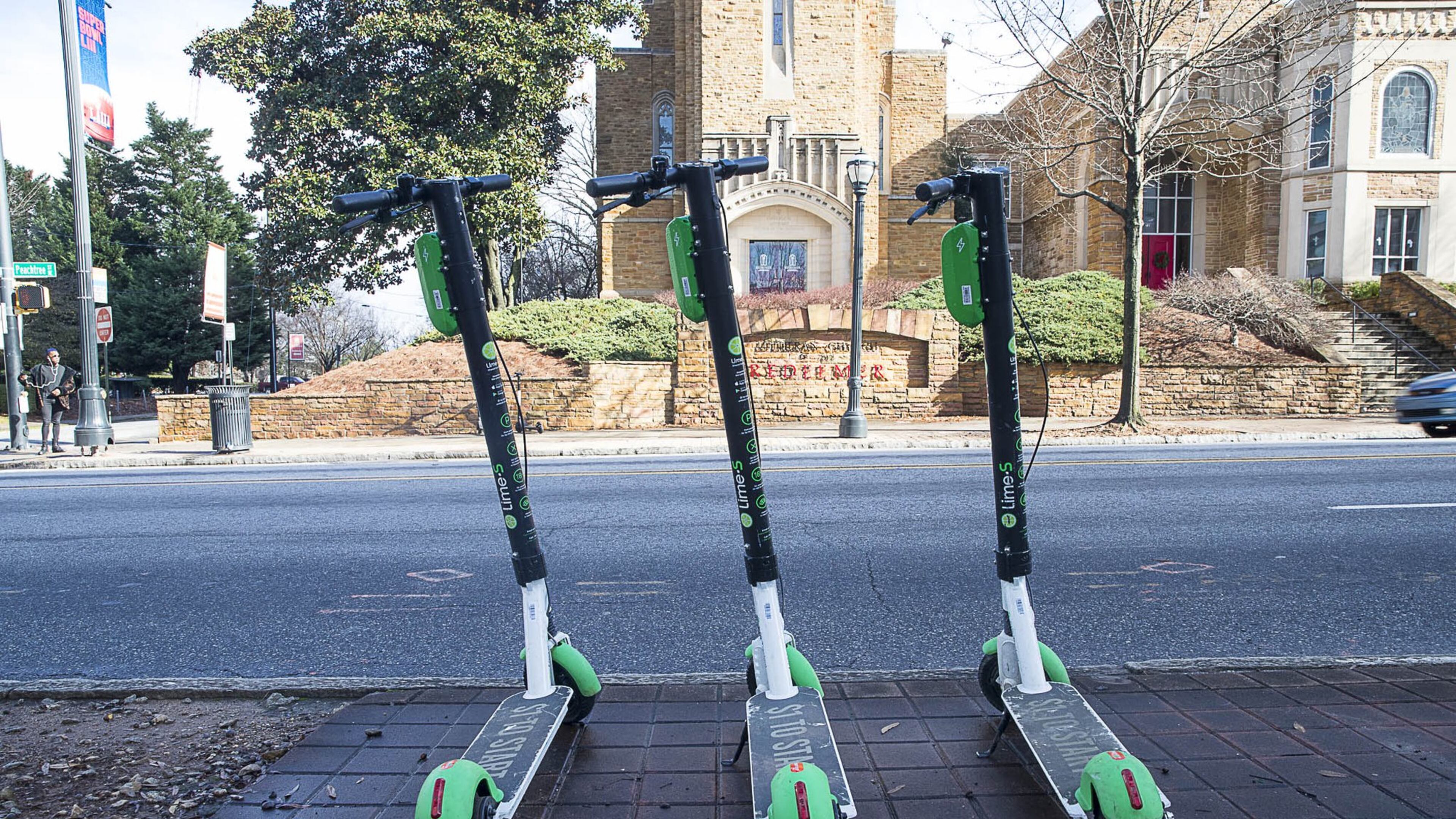 01/04/2019 — Atlanta, Georgia — Lime Scooters sit parked on the sidewalk on Peachtree Street in Atlanta’s Midtown community, Friday, January 4, 2019. (ALYSSA POINTER/ALYSSA.POINTER@AJC.COM)