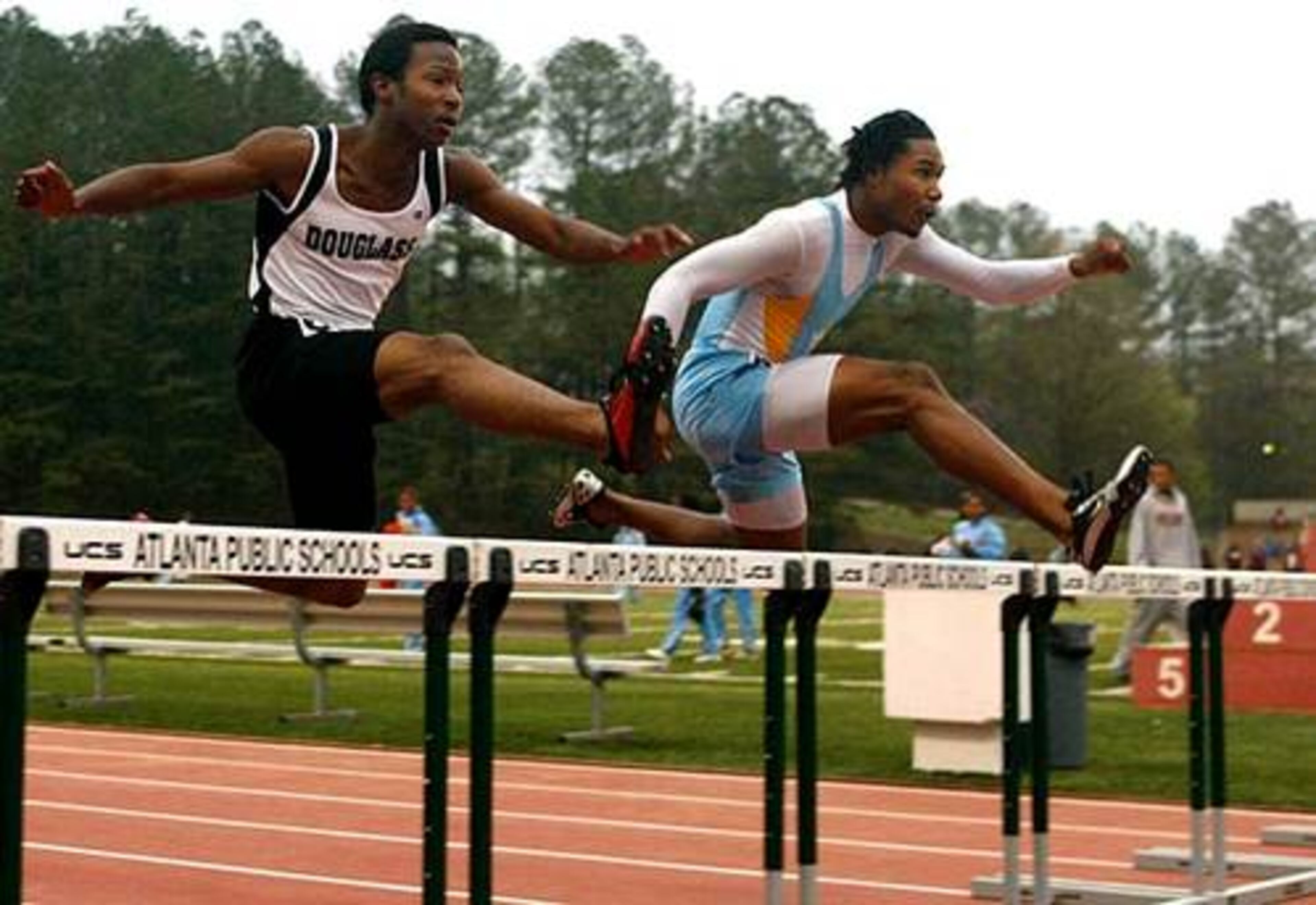 Mays' Corey Heard (right) is literally a foot ahead of Douglass' Machello Sinkfield (left) in the Boys' 300 Meter Hurdles during the Atlanta Track Classic at Lakewood Stadium in Atlanta April 3, 2008.