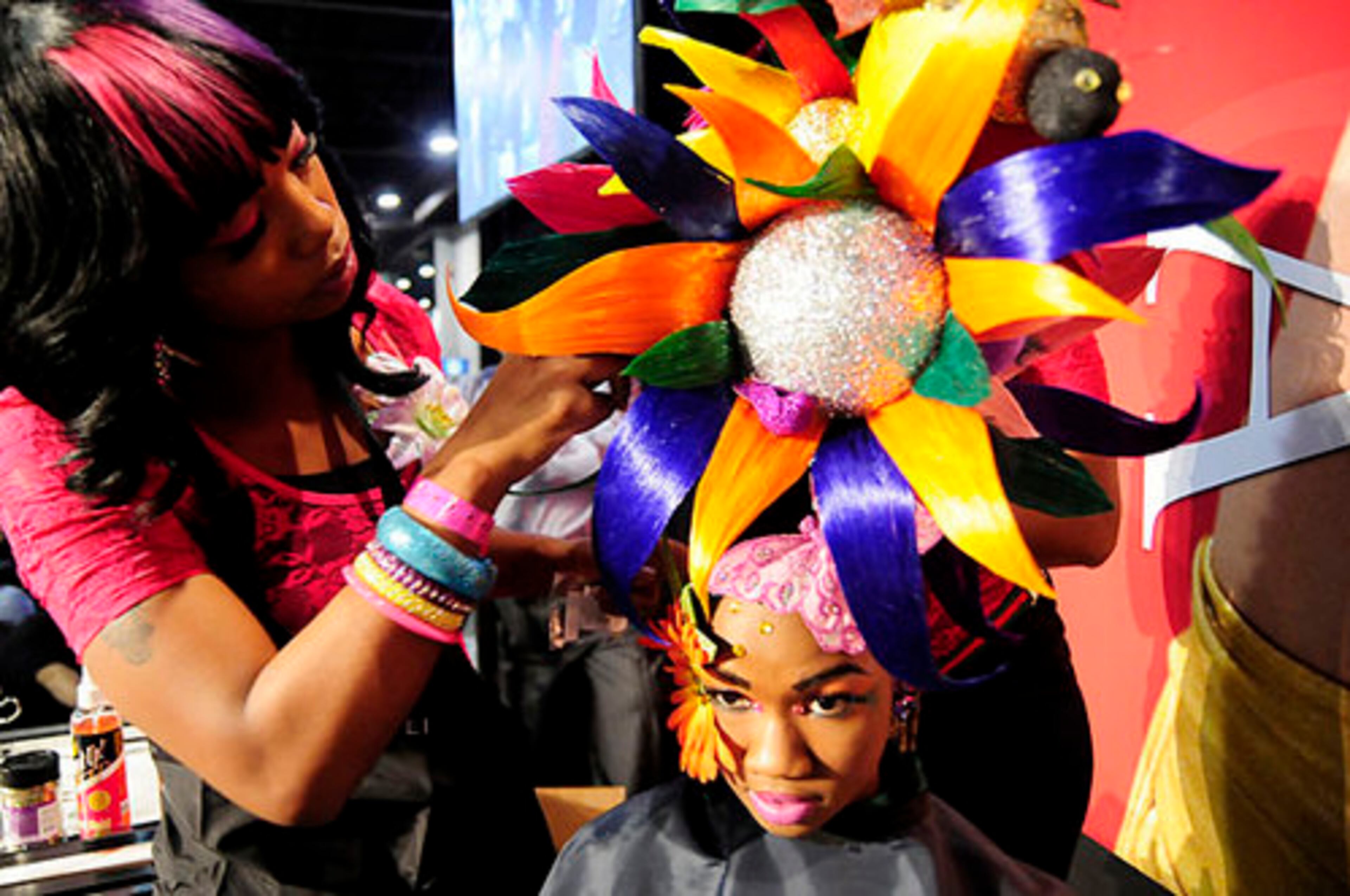 A stylist prepares a sunflower inspired hairstyle.