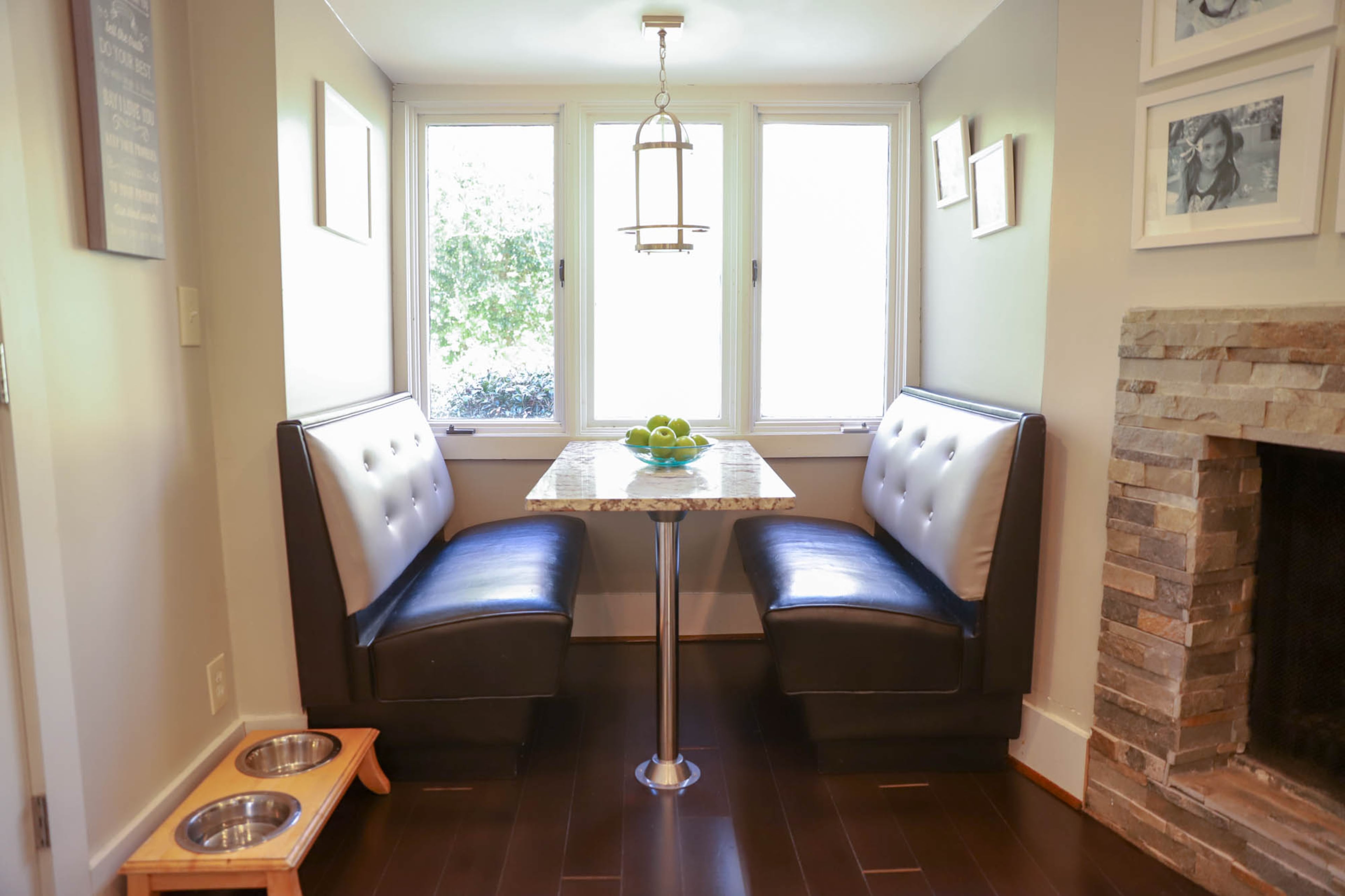 A cafe booth from a restaurant warehouse that Aaron restored and custom fit to the space makes family meals casual and cozy.