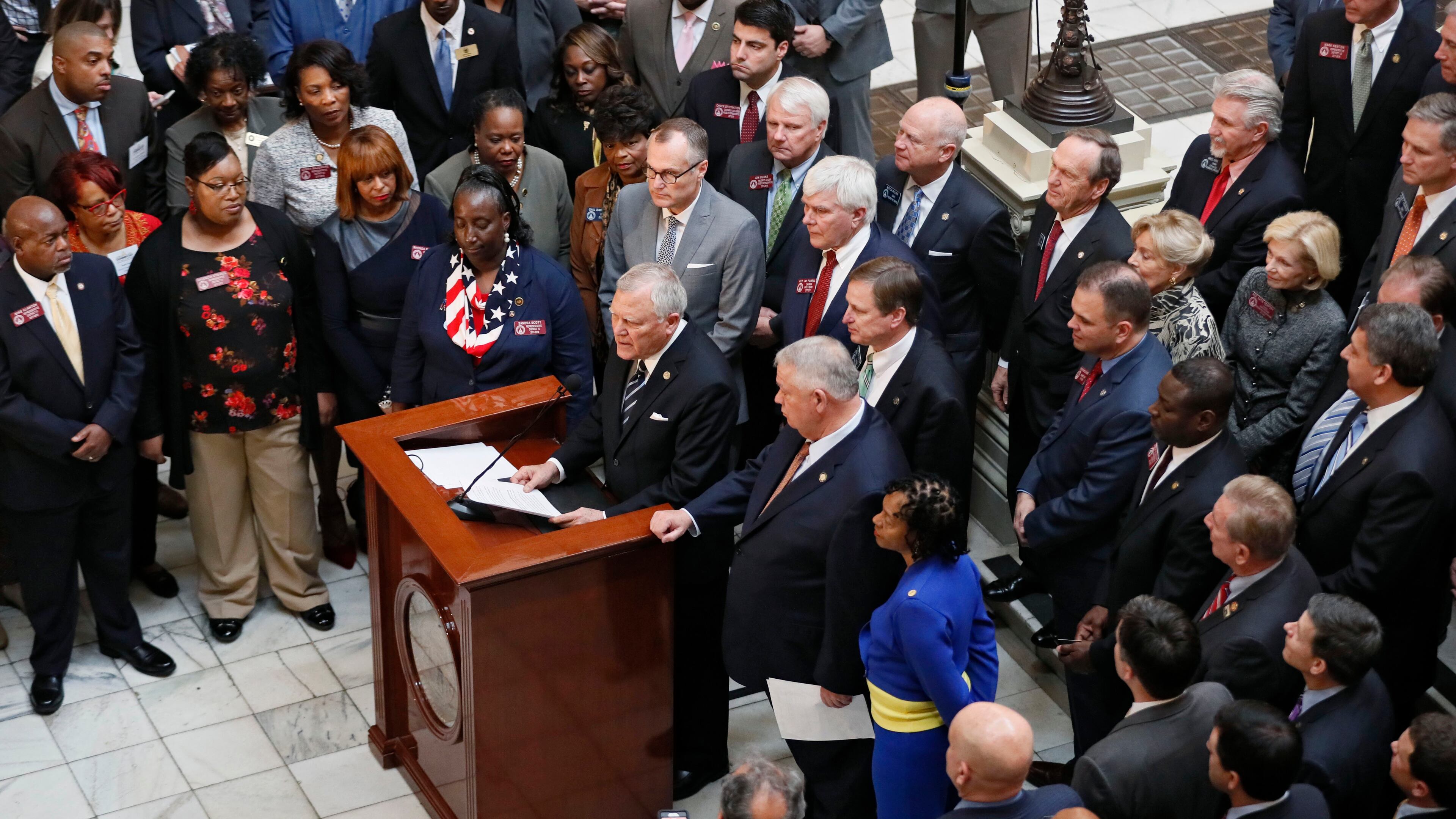 A bipartisan group of legislators joined Gov. Nathan Deal for Tuesday's announcement of an income-tax rate cut. (AJC Photo / Bob Andres)