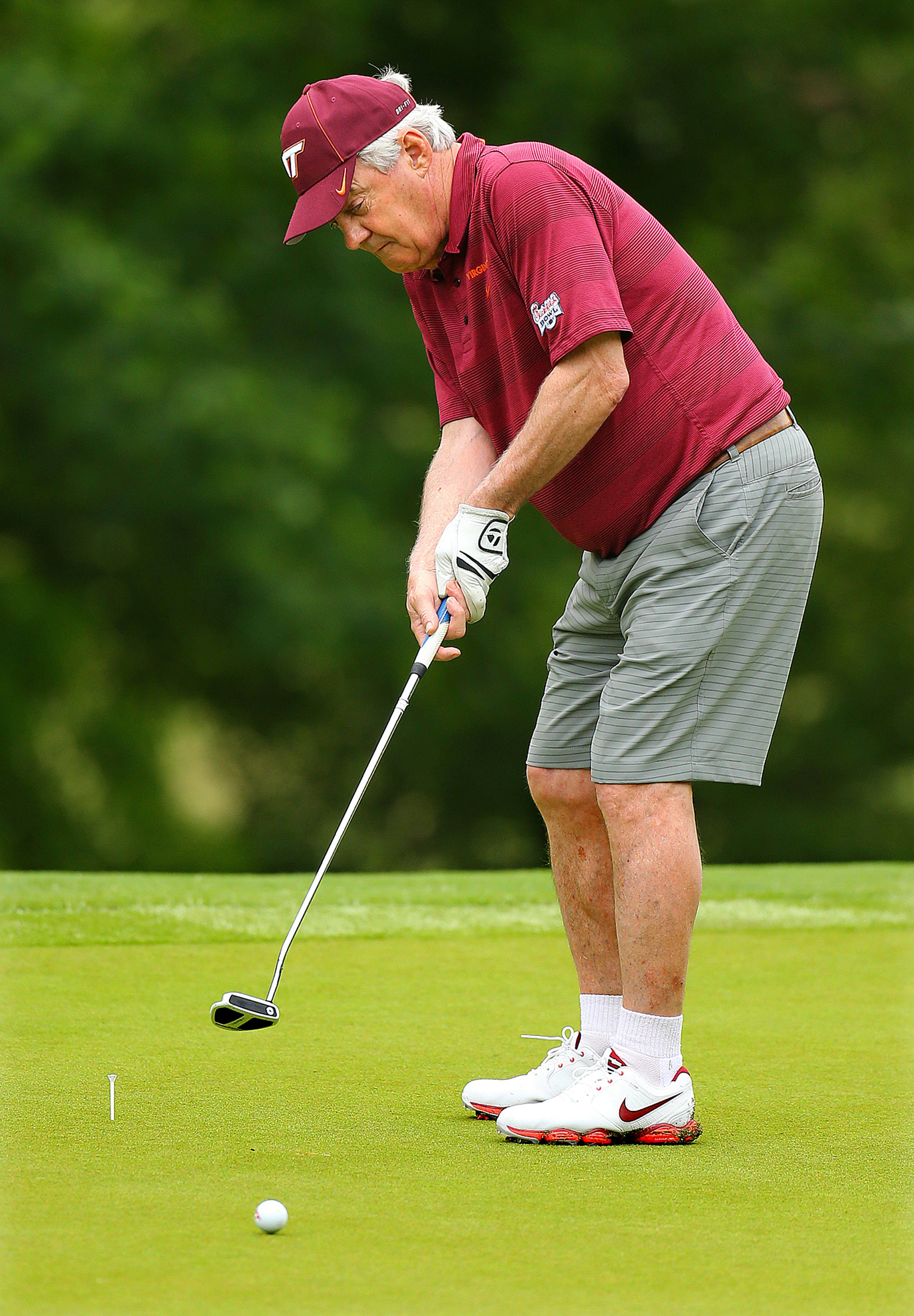Virginia Tech head football coach Frank Beamer putts on the No. 7 hole during the Chick-fil-A Bowl Challenge featuring an 11 team field of NCAA head coaches and celebrity alumni at Reynolds Plantation on Tuesday, April 29, 2014, in Greensboro. Teams compete for a share of the $520,000 scholarship purse for their universities. Beamer won the event in 2007. CURTIS COMPTON / CCOMPTON@AJC.COM