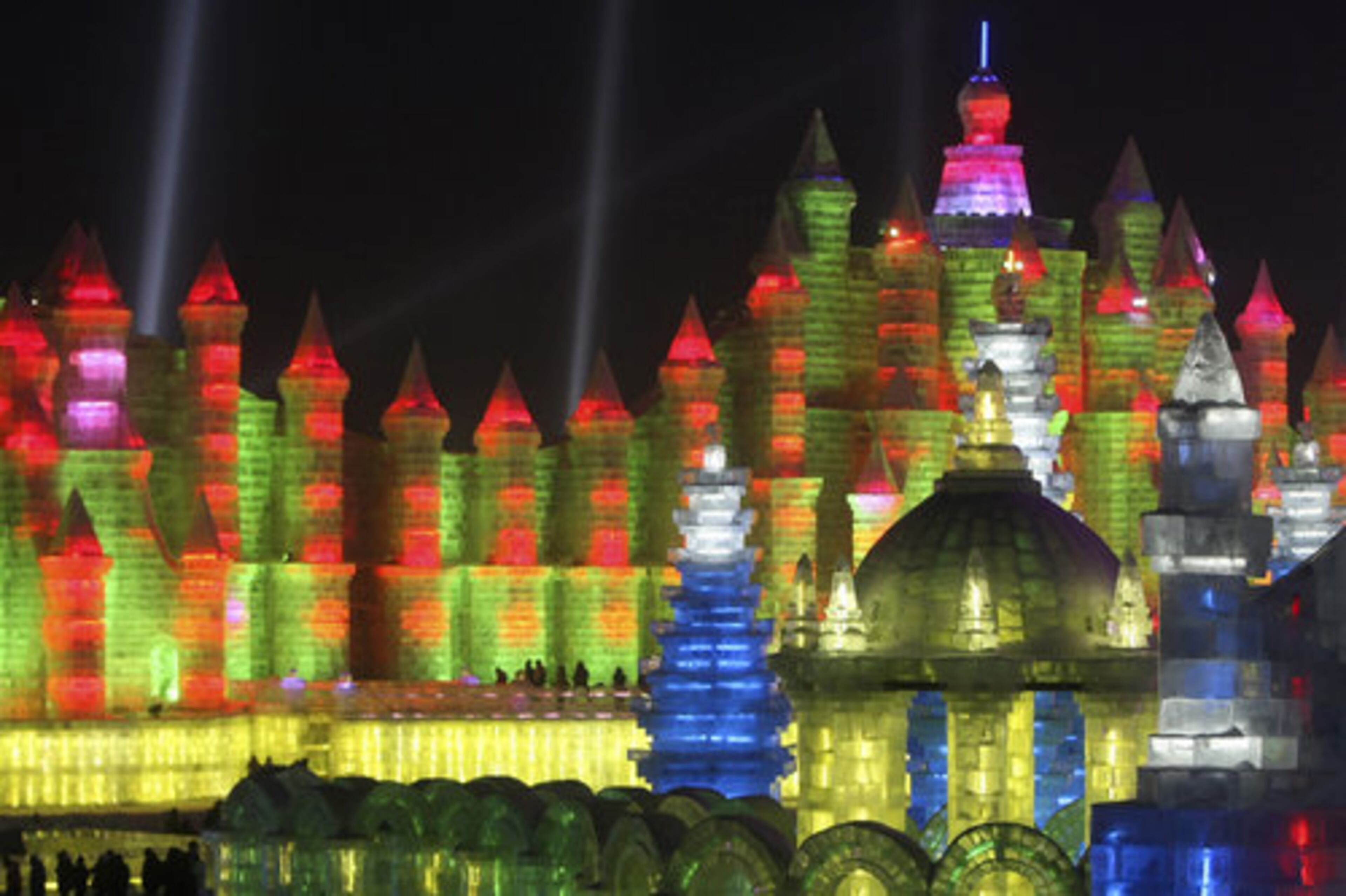 Visitors from around the world walk among giant, brightly-illuminated ice sculptures at the annual Harbin Ice and Snow Festival.