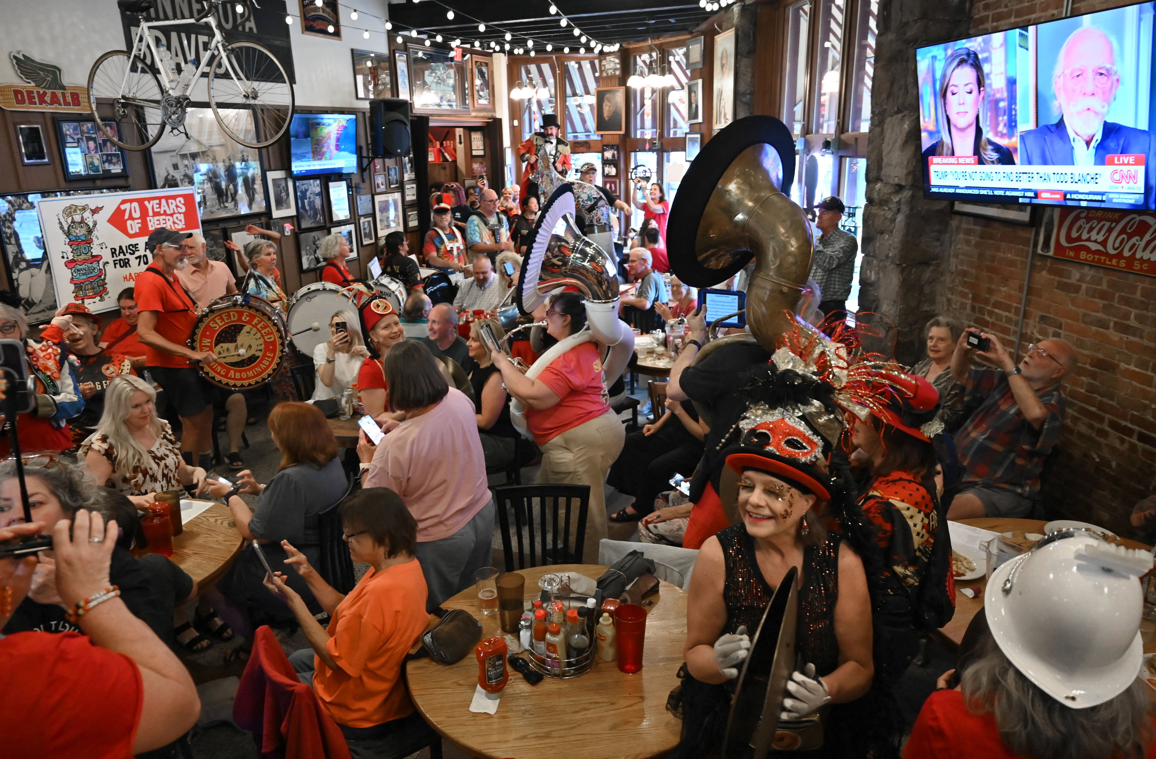 The Seed & Feed Marching Abominable performs during Manuel’s Tavern’s 70th anniversary celebration on Thursday, Aug. 6, 2026, in Atlanta. Manuel’s Tavern celebrates its 70th anniversary with a three-day festival beginning Thursday at its longtime North Highland Avenue location, featuring food specials, rare beers and live entertainment. (Hyosub Shin/AJC)